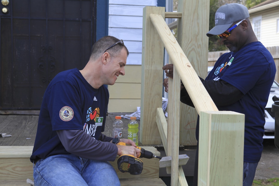ALGIERS, La. – Warren Brown, a New York native visiting New Orleans during NBA All-Star Weekend, and (ret.) Army Master Sgt. Kenneth Nixon, repair a porch on a house being renovated by the NBA Cares outreach event, Feb. 14, 2014. NBA Cares, a community-outreach initiative that focuses on community development, education and health, hosted an All-Star Day of Service that was staffed by volunteers from local areas, visitors from across the country and service members from all five branches of the U.S. military, as well as current and former NBA athletes. (U.S. Marine Corps photo by Cpl. Tiffany Edwards)