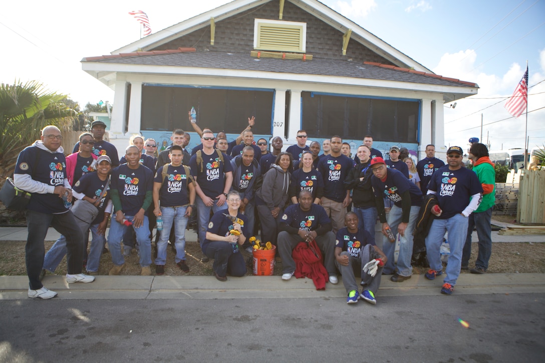 ALGIERS, La. – Volunteers with NBA Cares pose in front of a renovated house, Feb. 14, 2014. NBA Cares, a community-outreach initiative that focuses on community development, education and health, hosted an All-Star Day of Service that was staffed by volunteers from local areas, visitors from across the country and service members from all five branches of the U.S. military, as well as current and former NBA athletes. Volunteers renovated houses for veterans and low-income families in the Algiers Point neighborhood of New Orleans. (U.S. Marine Corps photo by Cpl. Tiffany Edwards)