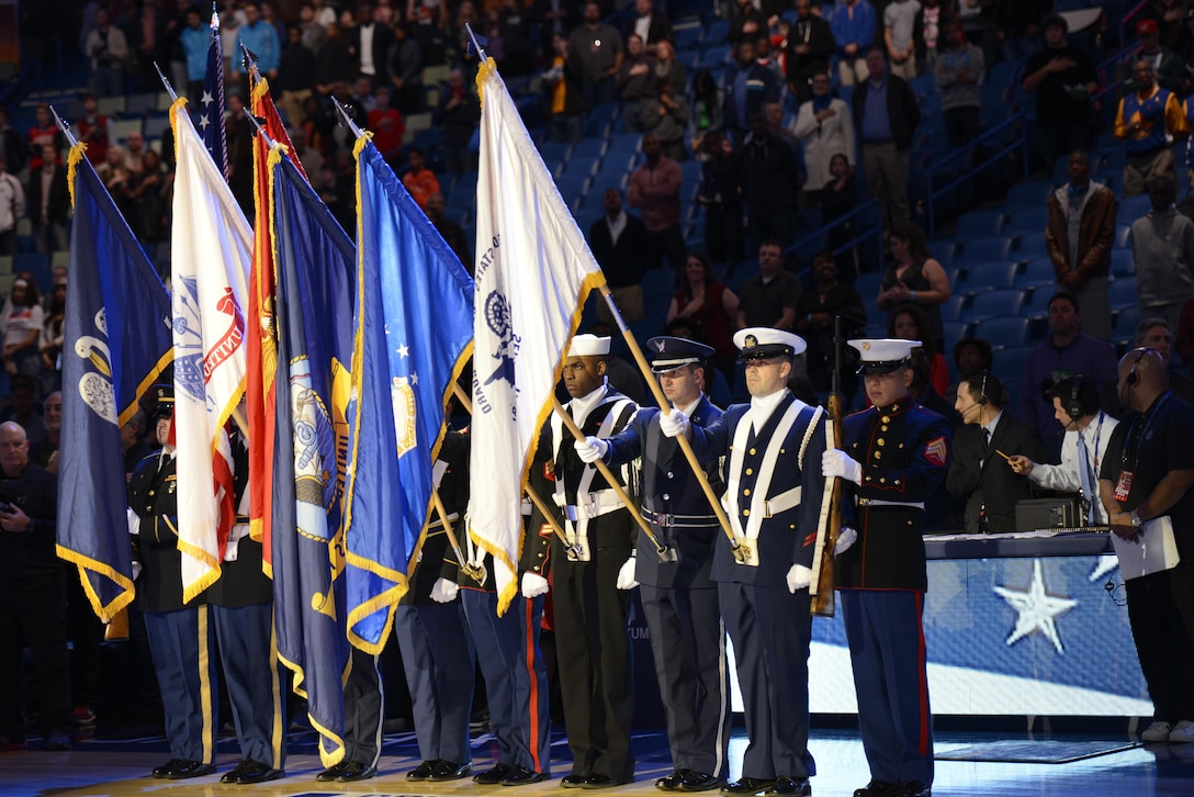 NEW ORLEANS- A joint service color guard presents the colors during the National Anthem before the NBA Rising Stars basketball game at the Smoothie King Center, Feb. 14, 2014. The Armed Forces community had the opportunity to participate in the 2014 NBA All-Star Weekend to highlight the military presence in the New Orleans area and support community outreach events. U.S. Coast Guard photo by Petty Officer 2nd Class William Benson.
