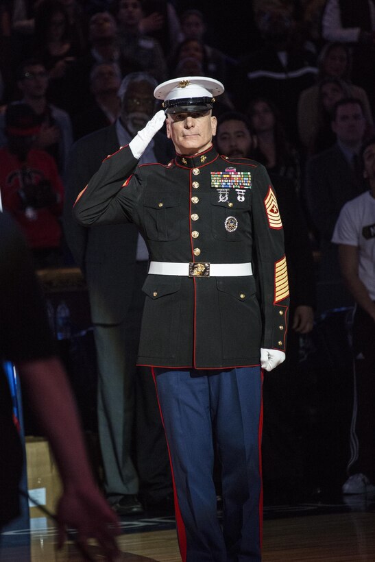U.S. Marine Sgt. Maj. Bryan Battaglia, 2nd Senior Enlisted Advisor to the Chairman of the Joint Chiefs of Staff, is honored during the National Anthem at the NBA All-Star Game inside the Smoothie King Center, New Orleans, La., Feb. 16, 2014. The Armed Forces community had the opportunity to participate in the 2014 NBA All-Star Weekend to highlight the military presence in the New Orleans area and support community outreach events. (U.S. Marine Corps photo by Lance Cpl. Mackenzie Schlueter/Released)
