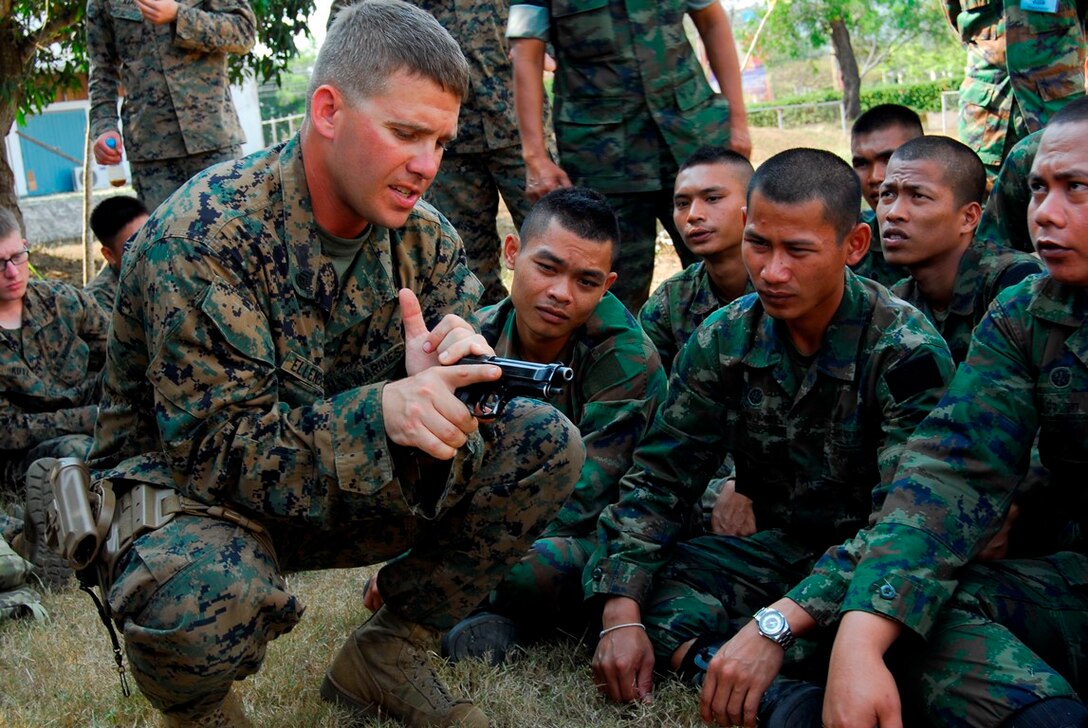 SAMAESAN, Thailand–Staff Sgt. Eric Ellenbergers demonstrates how to load a 9MM Beretta for the Royal Thai 1st Infantry Battalion, 1st Company,Feb. 10 in Samaesan, Kingdom of Thailand during exercise Cobra Gold 2014. CG is a recurring multinational and multiservice exercise, which takes place annually in the Kingdom of Thailand. Ellenbergers is a platoon sergeant from 3rd Law Enforcement Battalion, III Marine Expeditionary Force Headquarters Group. (U.S. Navy photo by Mass Communication Specialist 1st Class Joy M. Kirch-Kelling/Released.)