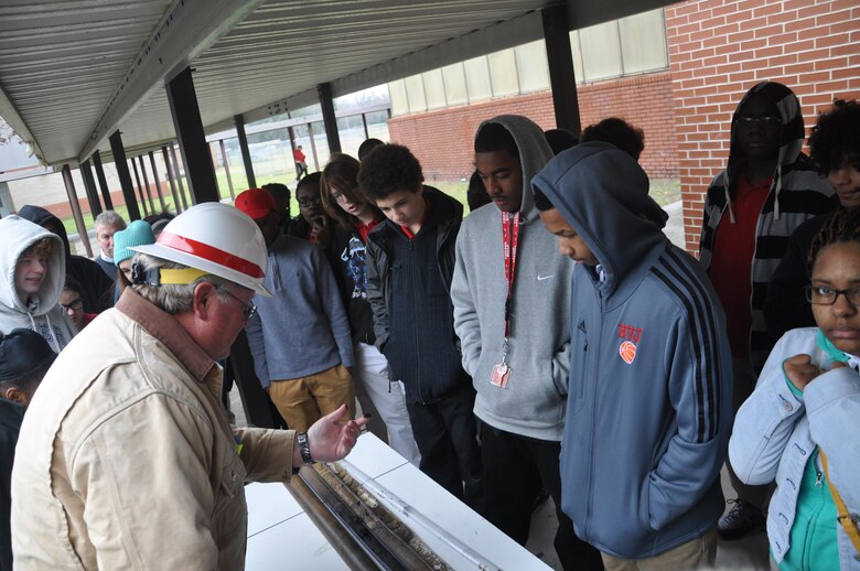 Danny Hewett, a drill rig operator with the U.S. Army Corps of Engineers Savannah District, shows students a soil sample extracted by a drill rig at Jenkins High School, Feb. 13, 2014. Members of the Corps visited Jenkins High School to promote engineering-related career paths as part of National Engineers Week.