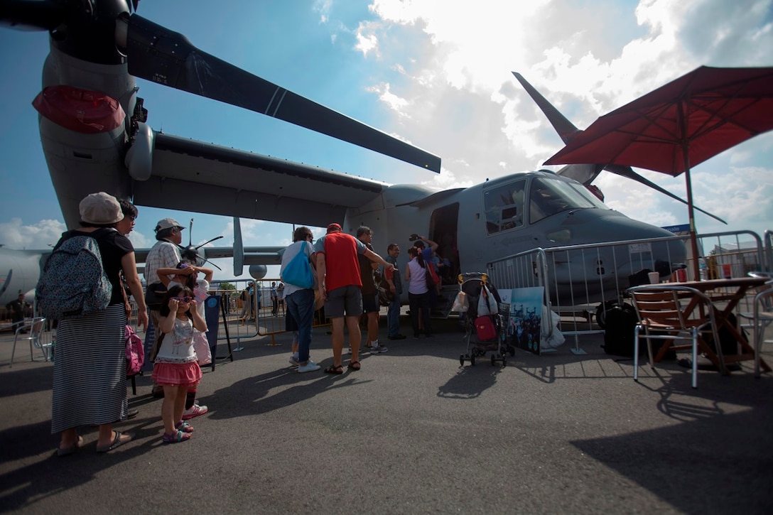 Members of the public line up outside of an MV-22B Osprey Feb. 15 during the Singapore International Airshow 2014 at the Changi Exhibition Center. The public days of the airshow gives the public a chance to get up-close and personal with military aircraft that they normally would never be able to touch or get inside. The Singapore International Airshow 2014 helps demonstrate strong U.S. and Singapore ties and flexible aircraft capability and enables engagement with foreign partners. The Osprey is with Marine Medium Tiltrotor Squadron 262, Marine Aircraft Group 36, 1st Marine Aircraft Wing, III Marine Expeditionary Force. (U.S. Marine Corps photo by Cpl. Lena Wakayama/Released)