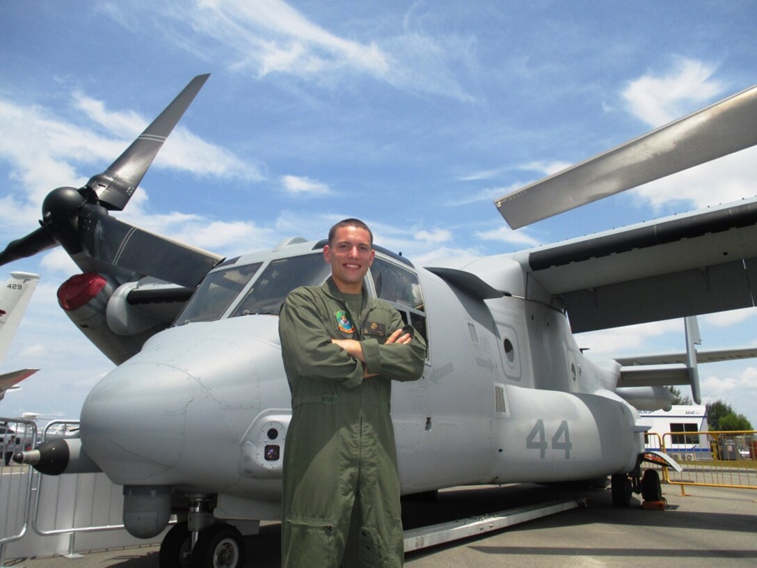 Sgt. James D. Schmidt, 26-year-old, of Eau Claire, Wisconsin, stands in front of an MV-22B Osprey Feb. 13 during the Singapore International Airshow 2014. The Singapore Air Show 2014 helps build stronger relations between the U.S. and Singapore, as well as among the international community. The event promotes military to military discussions on aircraft and equipment, which enables greater interoperability of aviation platforms, and furthers international military relationships and cooperation. The U.S. is committed to maintaining peace and stability in the region, and this event demonstrates a focus of the U.S. rebalance to the Asia-Pacific region. The Osprey is with Marine Medium Tiltrotor Squadron 262, Marine Aircraft Group 36, 1st Marine Aircraft Wing, III Marine Expeditionary Force. (U.S. Marine Corps photo by Capt. Caleb D. Eames/Released)