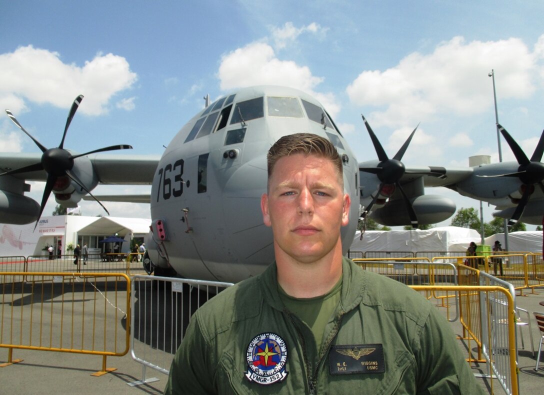 1st. Lt. William E. Wiggins, 27-years-old, of Rome, Ga., a KC-130 J Super Hercules pilot with Marine Refueler Transport Squadron 152 stands in front of his aircraft Feb. 13 during the Singapore International Airshow 2014. The Singapore Air Show 2014 helps build stronger relations between the U.S. and Singapore, as well as among the international community. The event promotes military to military discussions on aircraft and equipment, which enables greater interoperability of aviation platforms, and furthers international military relationships and cooperation. The U.S. is committed to maintaining peace and stability in the region, and this event demonstrates a focus of the U.S. rebalance to the Asia-Pacific region. VMGR-152 is with Marine Aircraft Group 36, 1st Marine Aircraft Wing, III Marine Expeditionary Force. (U.S. Marine Corps photo by Capt. Caleb D. Eames/Released)