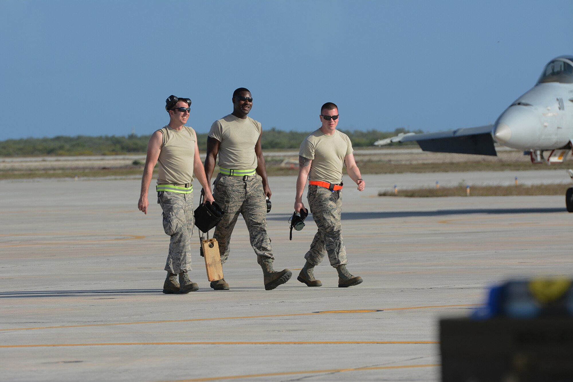 Airmen assigned to the 115th Fighter Wing exit the flightline after helping taxi an F-16 Fighting Falcon to the runway during a training exercise near Key West, Fla., Feb. 3, 2014. The 115th FW came to Key West in February to reduce the likelihood of flight cancelations due to weather. The deployment allowed pilots to test their expertise against dissimilar aircraft. (Air National Guard photo by Senior Airman Andrea F. Liechti)