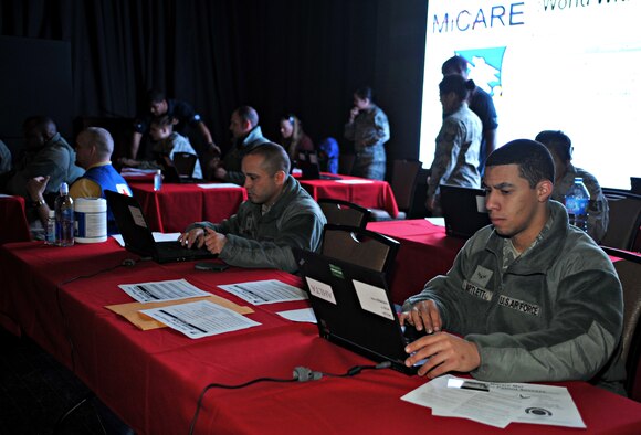 Osan Airmen register for the MiCARE smart phone application during a point of distribution exercise at Osan Air Base, Republic of Korea, Feb. 7, 2014. Service members and their families with the MiCARE application can electronically manage their medical information, make appointments for treatment at their local military treatment facility, and communicate securely with their healthcare provider. (U.S. Air Force photo/Airman 1st Class Ashley J. Thum)