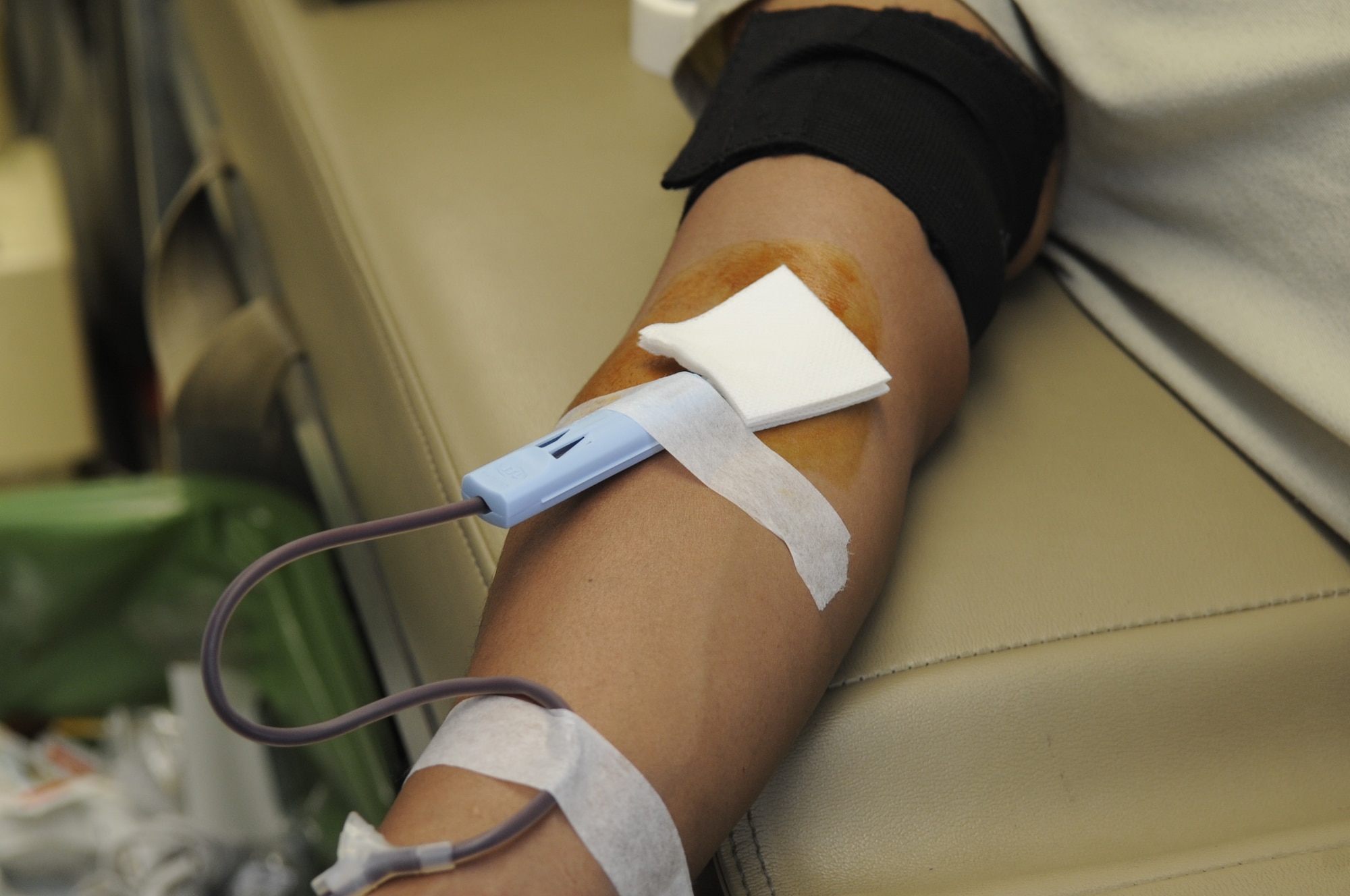 A needle draws blood from the arm of U.S. Air Force Airman 1st Class Jereck Alcos, 358th Aircraft Maintenance Unit A-10 crew chief, during an American Red Cross blood drive at Davis-Monthan Air Force Base, Ariz., Feb. 14, 2014. The 355th Maintenance Group hosted the blood drive for Airmen who work on the flightline, which more than 30 members participated in the event. (U.S. Air Force photo by Airman 1st Class Betty R. Chevalier/Released)