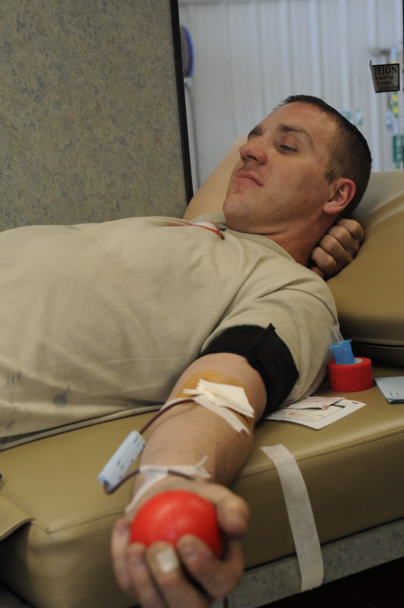 U.S. Air Force Senior Airman William Ballard, 358th Aircraft Maintenance Unit aircraft electrical and enviromental technician, donates blood to the American Red Cross at Davis-Monthan Air Force Base, Ariz., Feb. 14, 2014. During the donation, one pint of blood is collected which could save up to three lives. (U.S. Air Force photo by Airman 1st Class Betty R. Chevalier/Released)