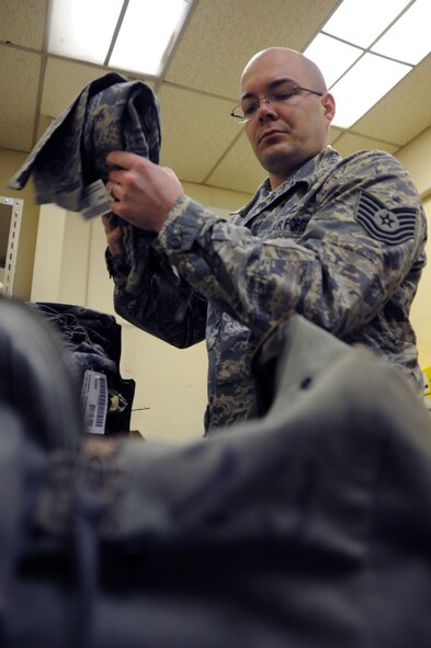 Tech. Sgt. Christopher Whitmore, 35th Maintenance Squadron unit deployment manager, prepares a deployment bag at Misawa Air Base, Japan, Feb. 18, 2014. Whitmore was selected by the 35 MXS as the Wild Weasel of the Week, which recognizes one Airman each week based on their superior performance, outstanding work ethic, and overall good conduct and discipline. (U.S. Air Force photo/Senior Airman Derek VanHorn)