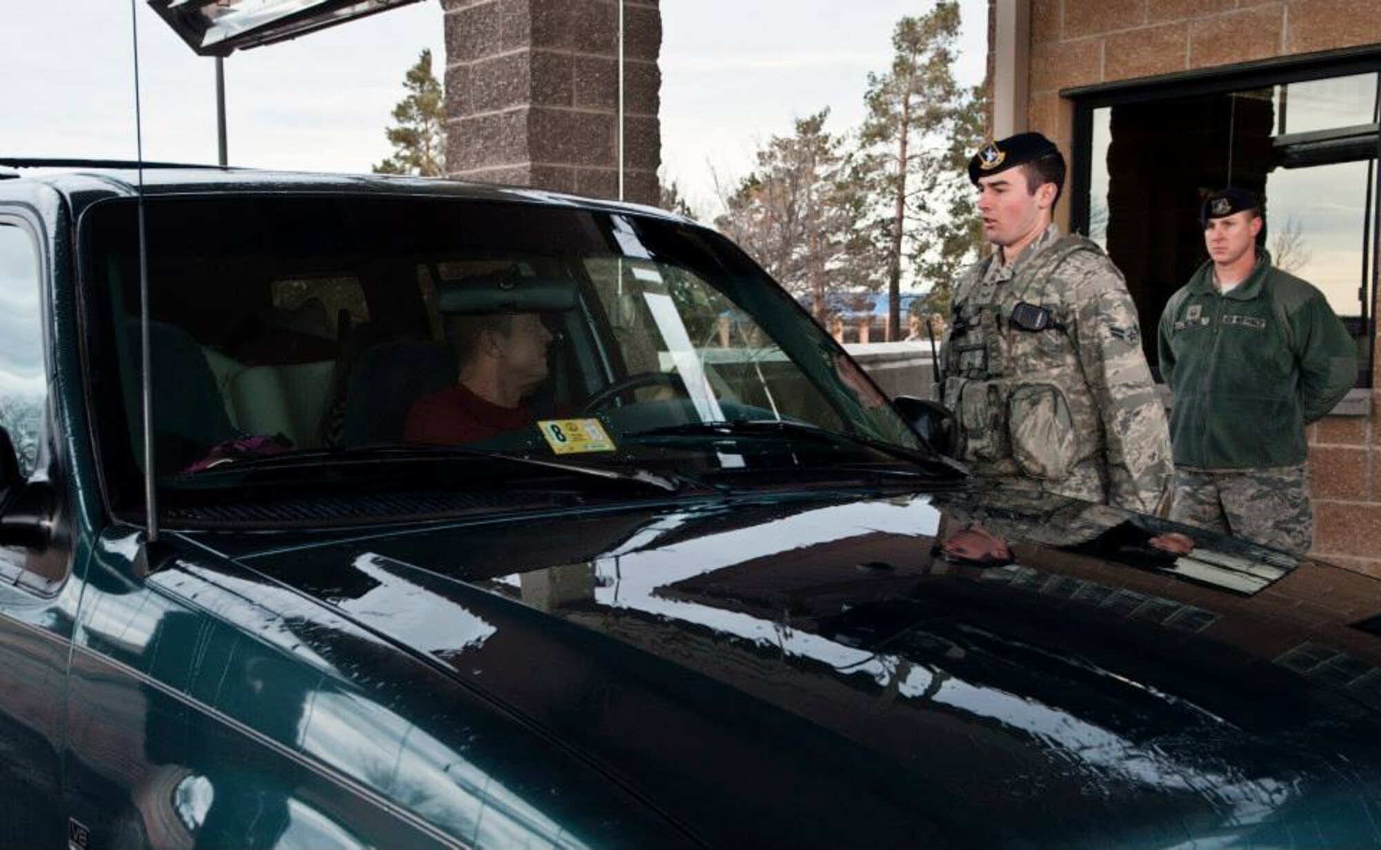 Airman 1st Class Cameron Keane, 366th Security Forces Squadron, recites a 'post brief' for Col. Dave Iverson, 366th Fighter Wing commander, as Iverson enters Mountain Home Air Force Base for his first time, Feb. 15, 2014. Iverson assumed command of the 366th FW from Col. Christopher Short. (U.S. Air Force photo by Master Sgt. Kevin Wallace/RELEASED)
