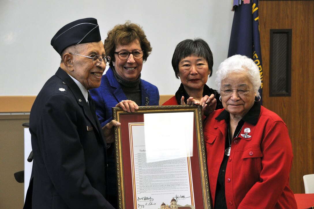 TRAVIS AIR FORCE BASE, Calif. -- Tuskegee Airmen were honored during the unveiling ceremony of the Tuskegee Airman Memorial Highway sign, at the Veterans Memorial Hall in Dixon, Calif., on Feb. 6. The section of Interstate 80, between Midway Road and Highway 12 has been dedicated to the Airmen. Retired Air Force Lt. Col. James Warren, a Tuskegee Airman, and Edith Roberts, wife of Tuskegee Airman Col. George S. Roberts, were guests of honor during the event. (U.S Air Force photo/Senior Airman Cindy Alejandrez)