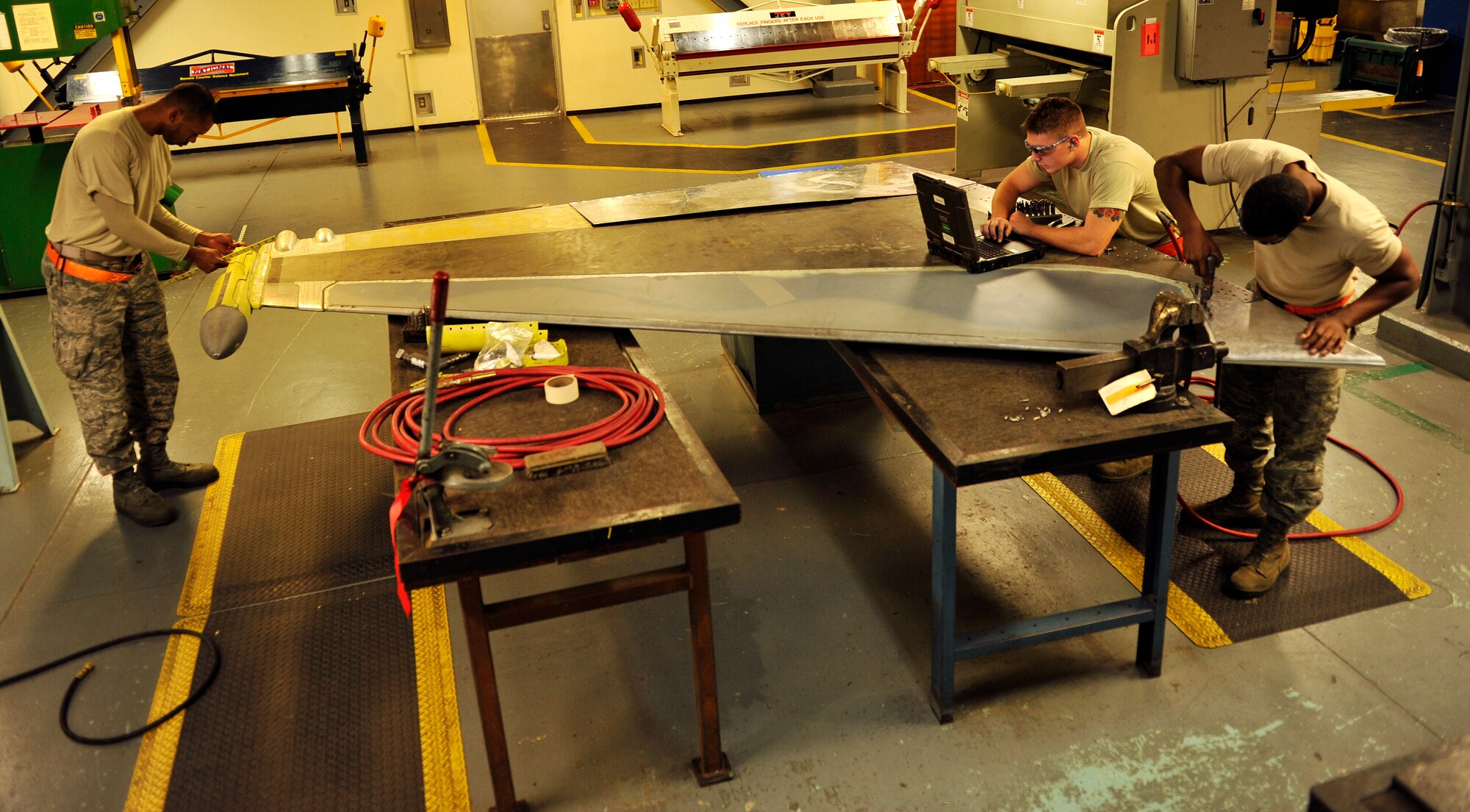 Members of the 18th Equipment Maintenance Squadron assemble the vertical stabilizer of an F-15 Eagle on Kadena Air Base, Japan, Feb. 14, 2014. The 18th EMS directly supports sortie production for a 14,000-hour annual flying program. (U.S. Air Force photo by Naoto Anazawa)

