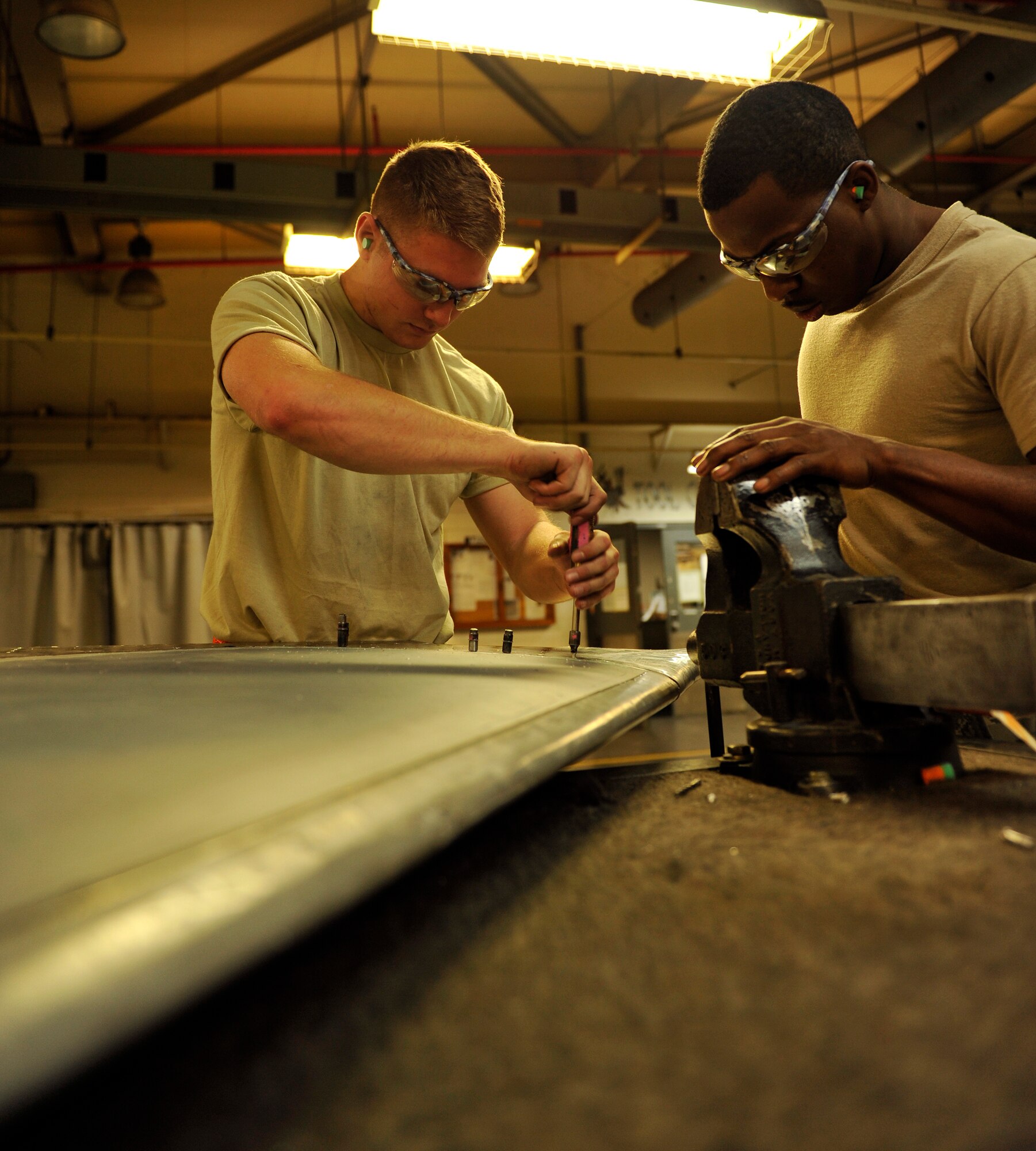 U.S. Air Force Airman Justin O'Neal (left), and Airman 1st Class Bryant Shockley (right), 18th Equipment Maintenance Squadron aircraft structural maintenance journeymen, assemble the vertical stabilizer of an F-15 Eagle on Kadena Air Base, Japan, Feb. 14, 2014. The 18th EMS operates 24/7 to provide metal work for all the aircraft located on Kadena. (U.S. Air Force photo by Naoto Anazawa)


