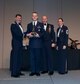 Col. John S. Tuohy, Washington Air National Guard Assistant Adjutant General, Chief Master Sgt. James W. Hotaling Air National Guard Command Chief and Chief Master Sgt. Trisha D. Almond Washington Air National Guard Command Chief,  present Air National Guard Senior Airman Jessie Clifford, Western Area Defense Sector,  tracking technician, the Honor Guard Member of the Year trophy at the Washington Air National Guard Annual Awards Banquet at the Spokane Convention Center, Spokane, Wash. Feb. 8, 2014. Clifford was awarded the trophy for his outstanding contributions to the Washington Air National Guard over the last year. (U.S. Air National Guard Photo by Tech. Sgt. Michael L. Brown/Released)
