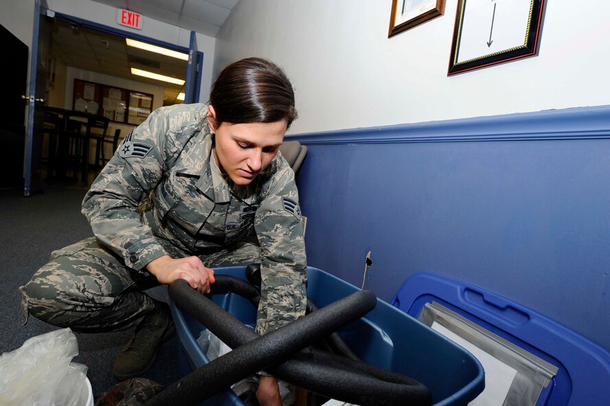Senior Airman Rebekah Beagle, 22nd Civil Engineer Squadron readiness and emergency management journeyman, inspects a shelter-in-place kit during a staff assistance visit Feb. 18, 2014, at McConnell Air Force Base, Kan. Staff assistance visits are performed annually with every unit on base in order to check readiness and emergency management standards compliance. (U.S. Air Force photo/Airman 1st Class Victor J. Caputo)