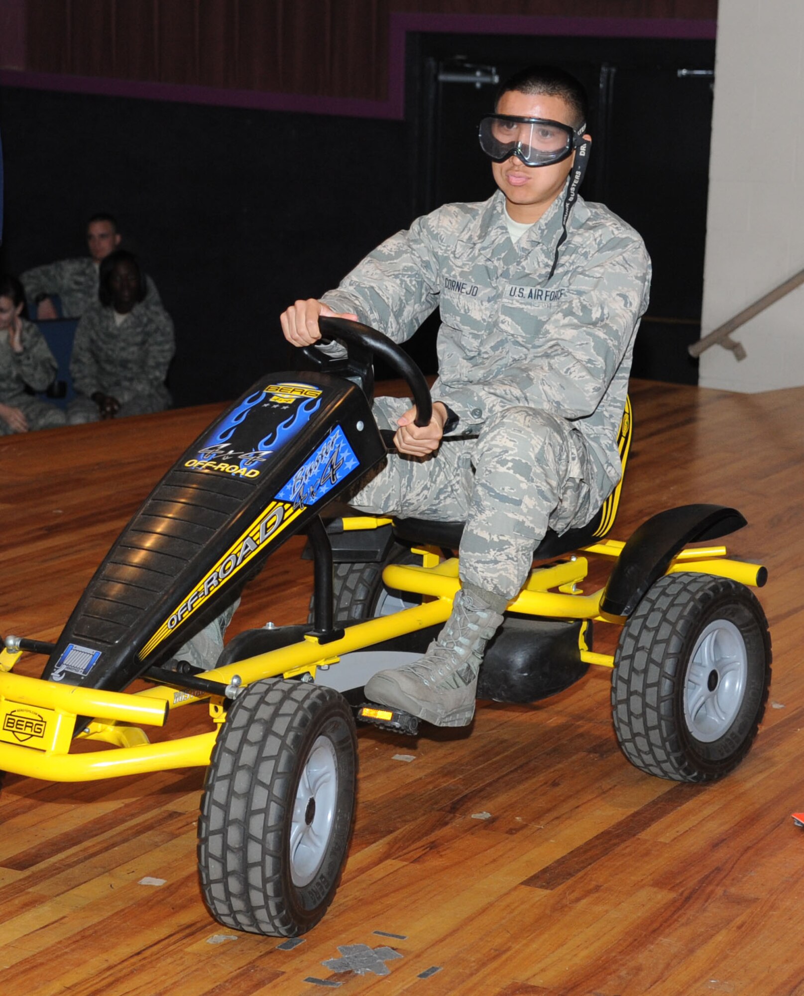 Airman Basic Esteban Cornejo, 334th Training Squadron, operates a peddling cart  while wearing drunk goggles to simulate being intoxicated over the legal limit during a drunk busters program Feb. 14, 2014, at the Welch Theater, Keesler Air Force Base, Miss.  The drunk busters program illustrates the impact and effects of alcohol on a person’s senses and motor skills and is offered to those Airmen getting more responsibility through increase in transition privileges.  (U.S. Air Force photo by Kemberly Groue)