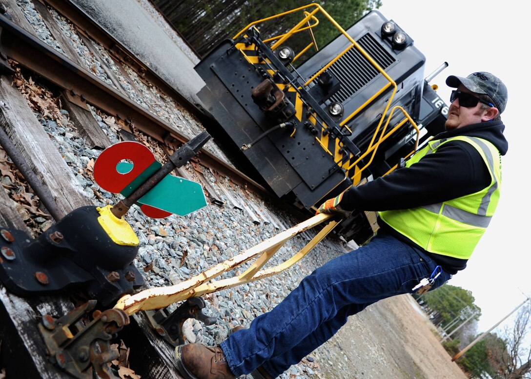 Bryan Jenkins, 733rd Logistics Readiness Division Utility Rail Branch engineer, changes a rail switch at Fort Eustis, Va., Feb. 7, 2014. The URB team has access to three trains: one with a 670-horsepower engine and two with 1,750 horsepower. (U.S. Air Force photo by Senior Airman Austin Harvill/Released)