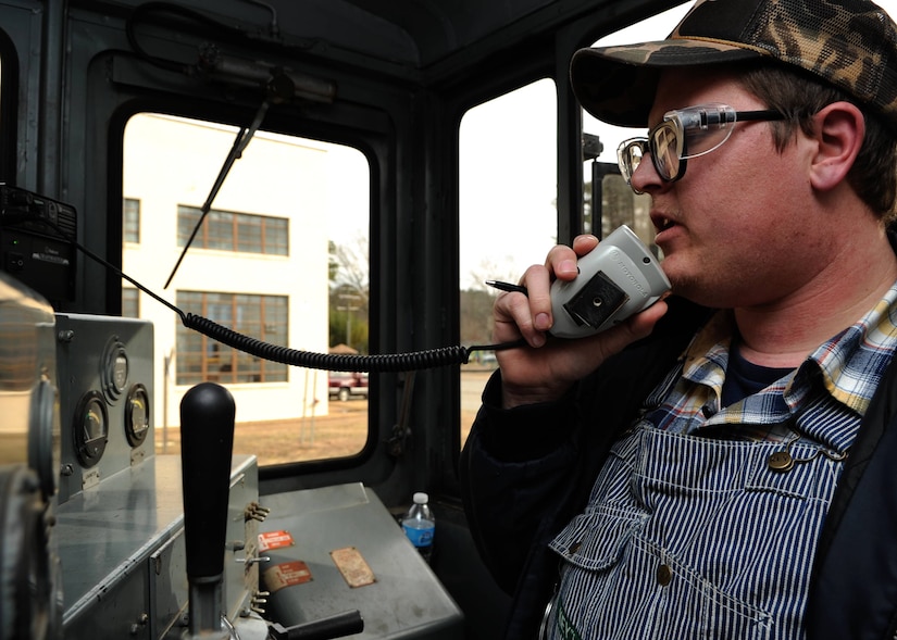 Billy Grimes, 733rd Logistics Readiness Division Utility Rail Branch engineer, communicates with his team before a transport mission at Fort Eustis, Va., Feb. 7, 2014. Grimes said the Fort Eustis rail team moved about 1,800 Humvees in 2004 in support of Operation Iraqi Freedom. (U.S. Air Force photo by Senior Airman Austin Harvill/Released)