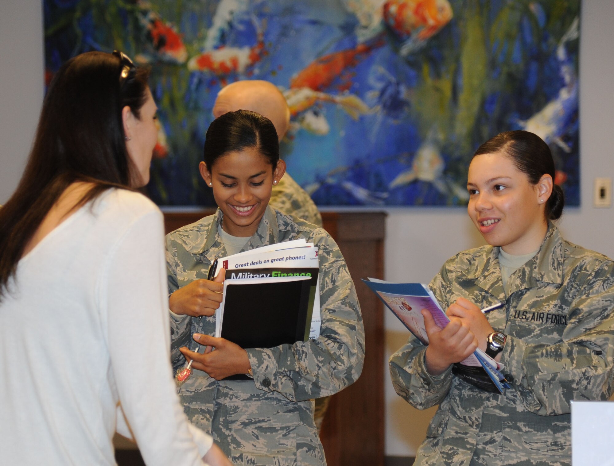 Natalie White, 81st Force Support Squadron marketing specialist, provides information about base activities to Airmen Basic Andrea Raudales and Amanda Marrero, 335th Training Squadron, during the “Right Start” program Feb. 14, 2014, at the Levitow Training Support Facility, Keesler Air Force Base, Miss.  The “Right Start” program, which replaced seven hours of power point briefings, is an interactive program that allows the Airmen to get direct information from base support and morale agencies. (U.S. Air Force photo by Kemberly Groue)