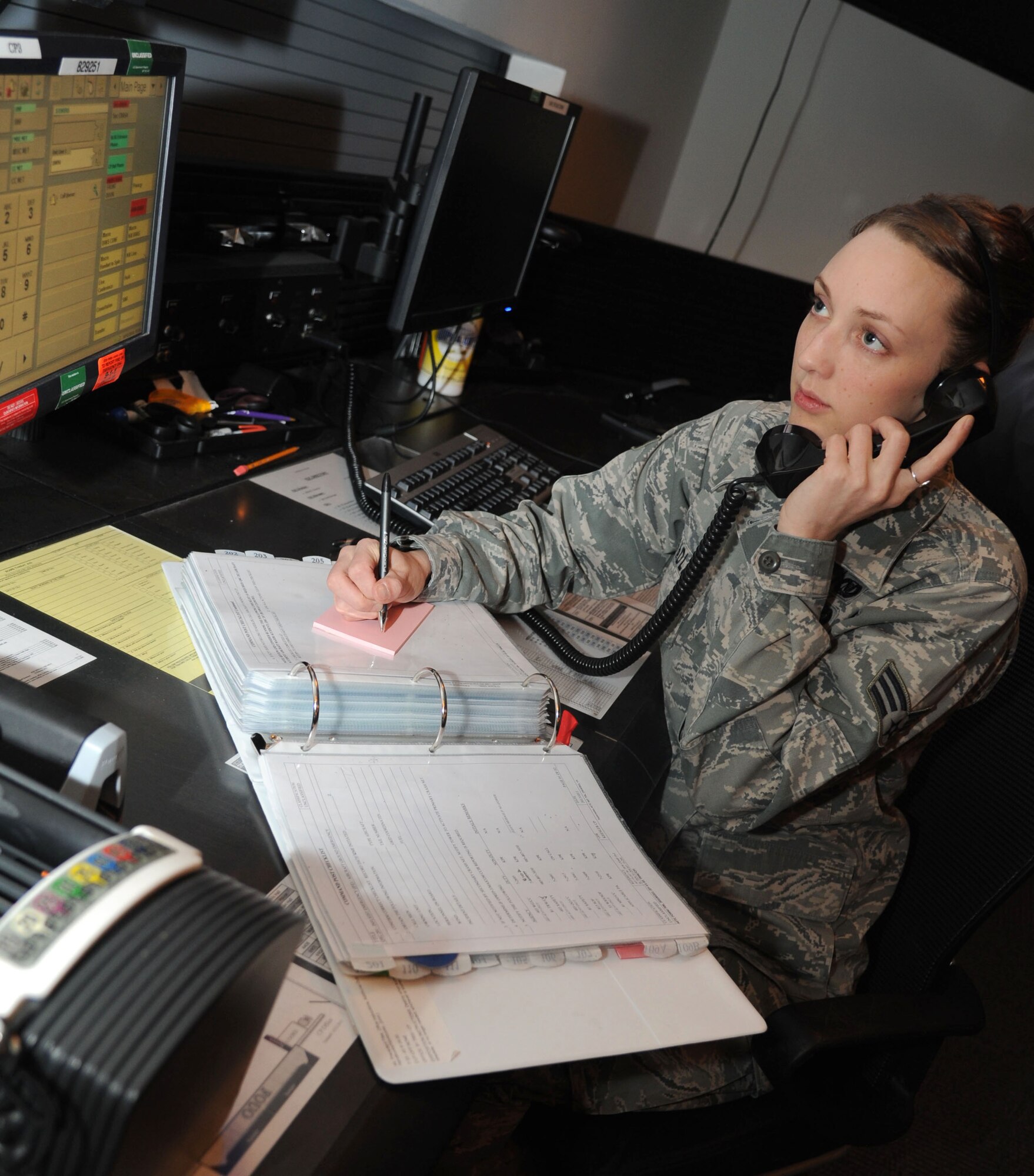 Senior Airman Melissa Bradley, 81st Training Wing command post, logs an incoming phone call inside the command post Feb. 14, 2014, Keesler Air Force Base, Miss.  Bradley was awarded the Air Education and Training Command Elizabeth Jacobson Award and the 438th Air Expeditionary Wing Airman of the Year.  (U.S. Air Force photo by Kemberly Groue)