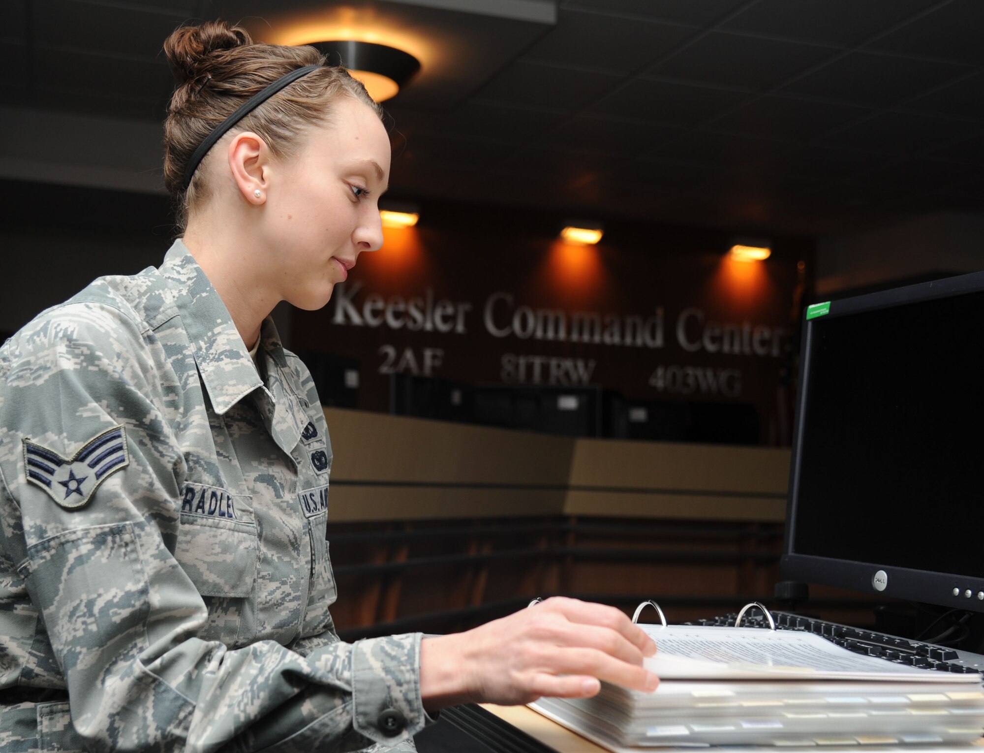 Senior Airman Melissa Bradley, 81st Training Wing command post senior emergency actions controller, reviews a crisis action log inside the Keesler Command Center Feb. 14, 2014, at Keesler Air Force Base, Miss.  Bradley was awarded the Air Education and Training Command Elizabeth Jacobson Award and the 438th Air Expeditionary Wing Airman of the Year.  (U.S. Air Force photo by Kemberly Groue)