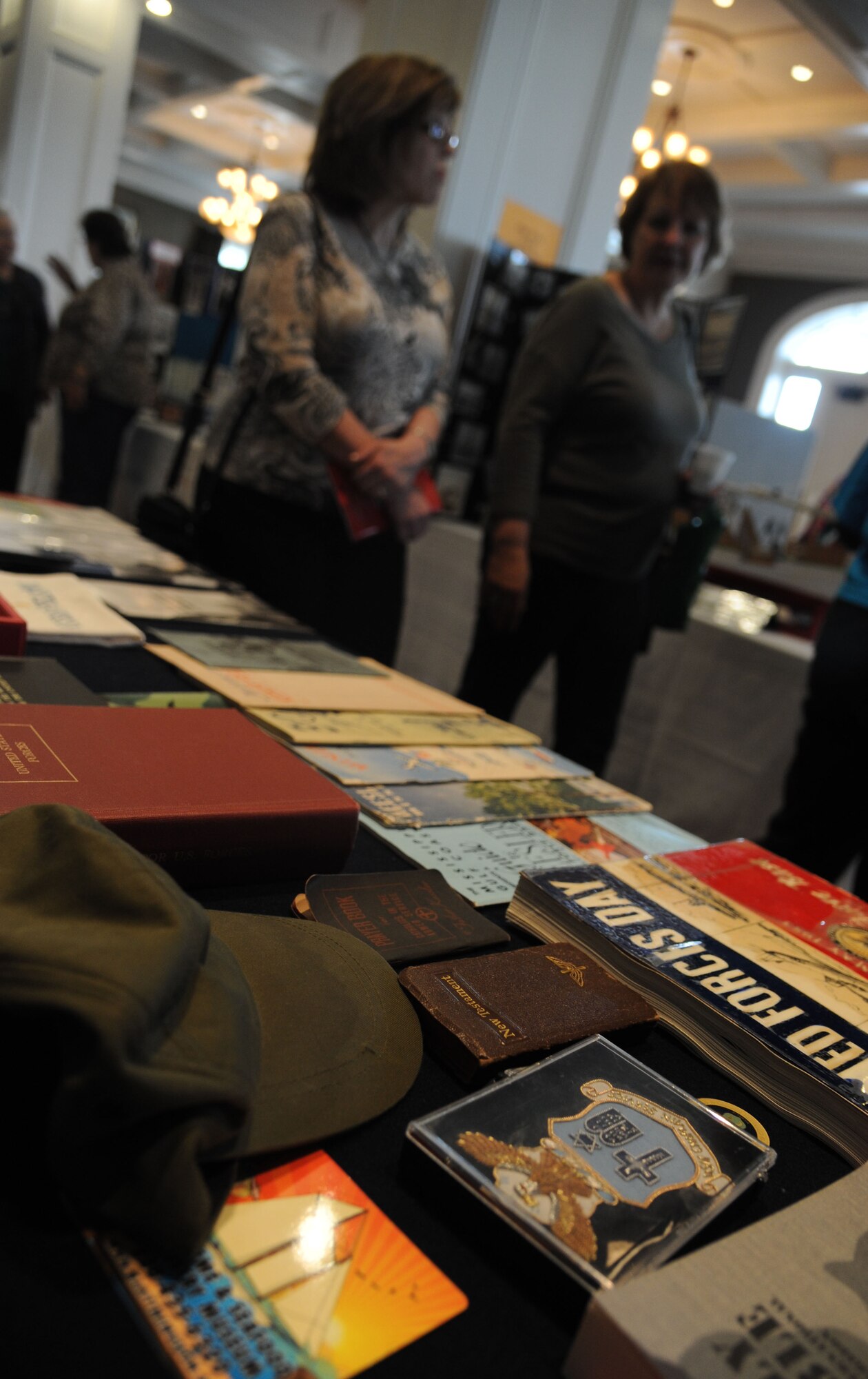 Deedie Robison, from Lafayette, La., and Jan Black, from Houston, walk past a table with Keesler Air Force Base memorabilia on display at a Biloxi history week event Feb. 18, 2014, at the Biloxi, Mississippi Visitor Center.  The event was held from Feb. 16-18.  (U.S. Air Force photo by Kemberly Groue)