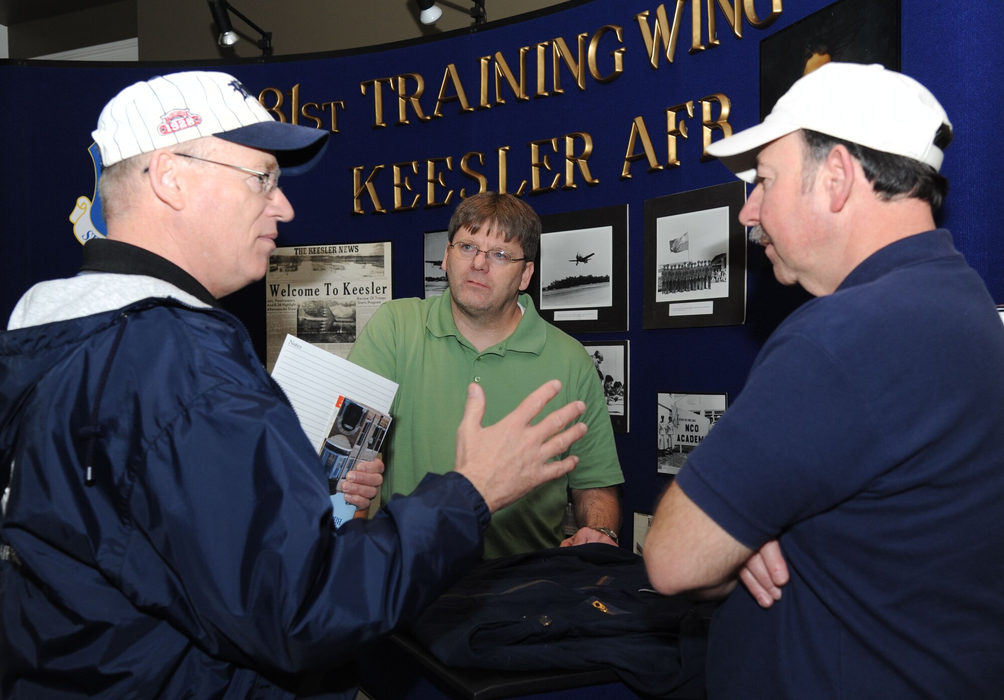 Jerry Marshall, a retired Chief Master Sgt. from Kansas City, Kan., speaks to Ken Dodd, 81st Training Wing historian, and James LaChute, 338th Training Squadron, about the history of Keesler Air Force Base during a Biloxi history week event Feb. 18, 2014, at the Biloxi, Mississippi Visitor Center.  The event was held from Feb. 16-18.  (U.S. Air Force photo by Kemberly Groue)