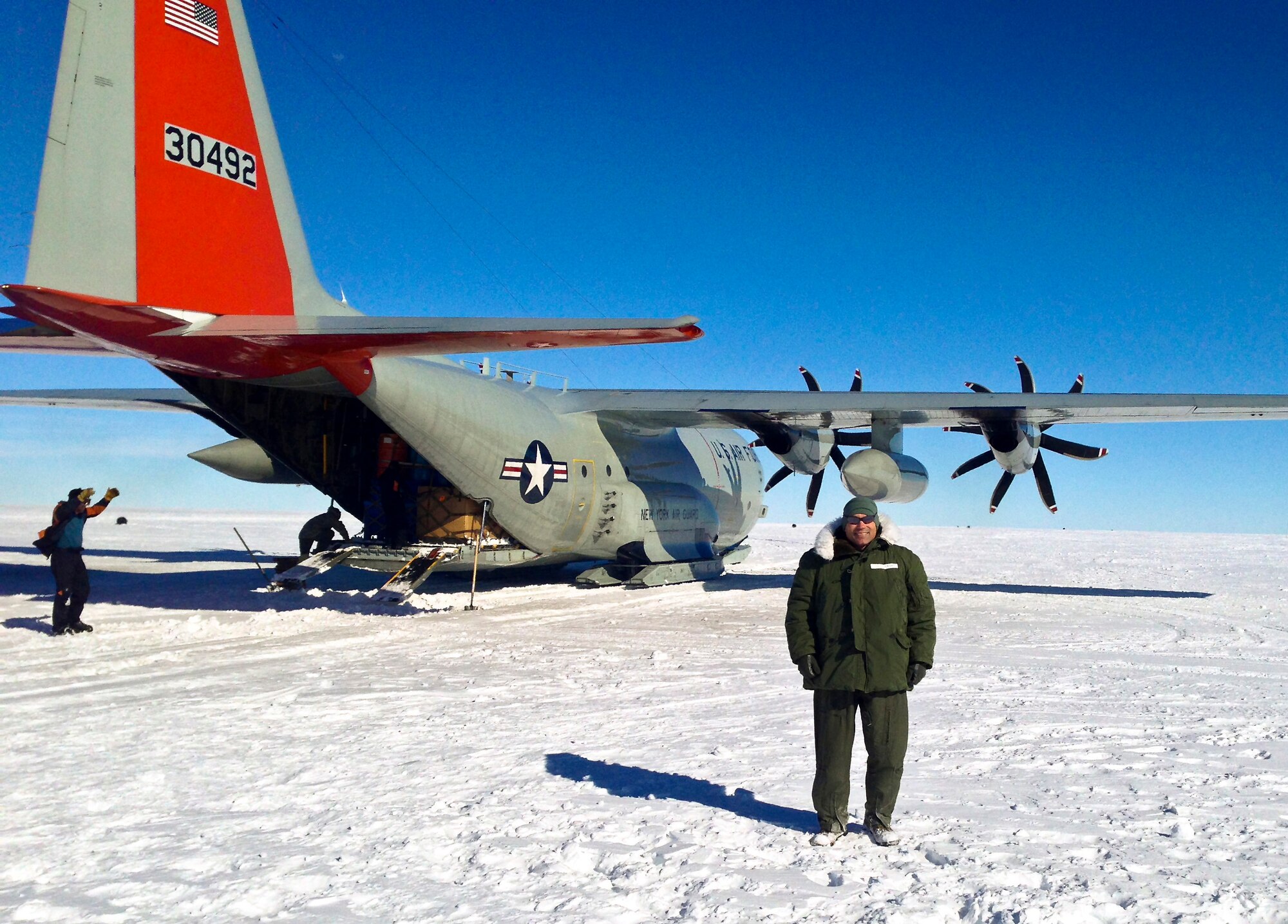 U.S. Air Force Col. Steven S. Norris, 182nd Medical Group commander, stands with a LC-130 Hercules during his deployment to McMurdo Station, Antarctica, Nov. 26, 2013. The doctor deployed as a flight surgeon in support of Operation Deep Freeze’s mission to provide airlift for the National Science Foundation. There, the Iraq and Afghanistan War veteran with almost two decades of military service experienced the most limited and remote working conditions of his career. (Courtesy photo from Col. Steven Norris/Released)