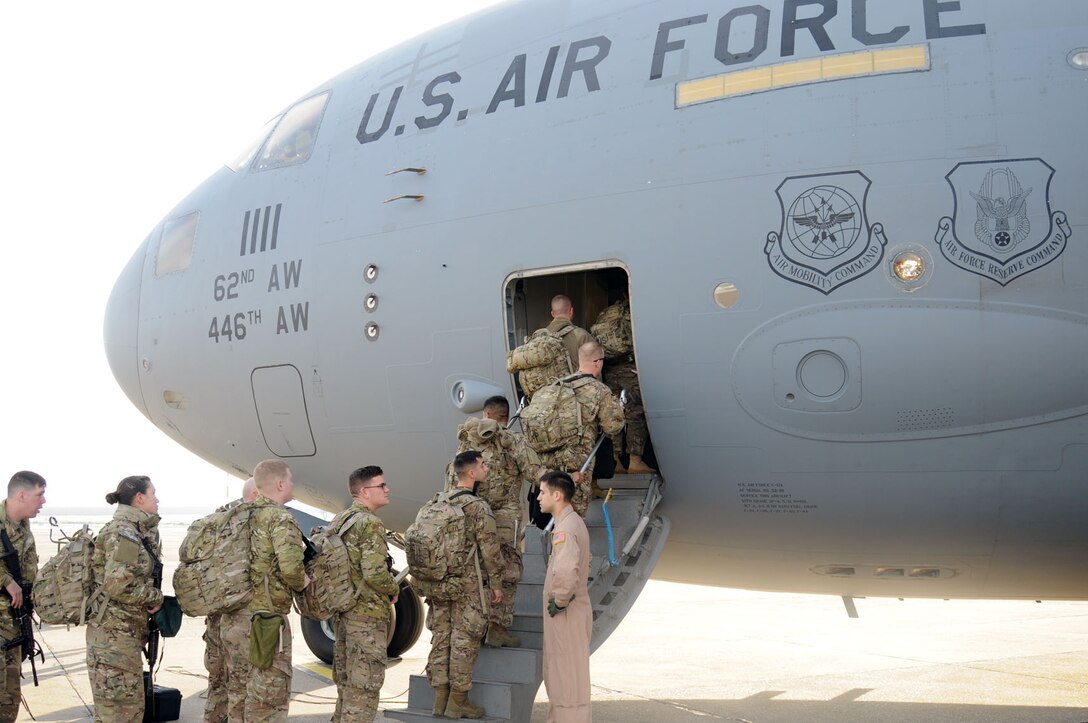 MIHAIL KOGALNICEANU AIR BASE, Romania - Servicemembers board a C-17 bound for Afghanistan. After more than a decade of operations at Manas, Kyrgystan, the Romanian location has become the U.S. military's main air hub for passengers and cargo into and out of Afghanistan.