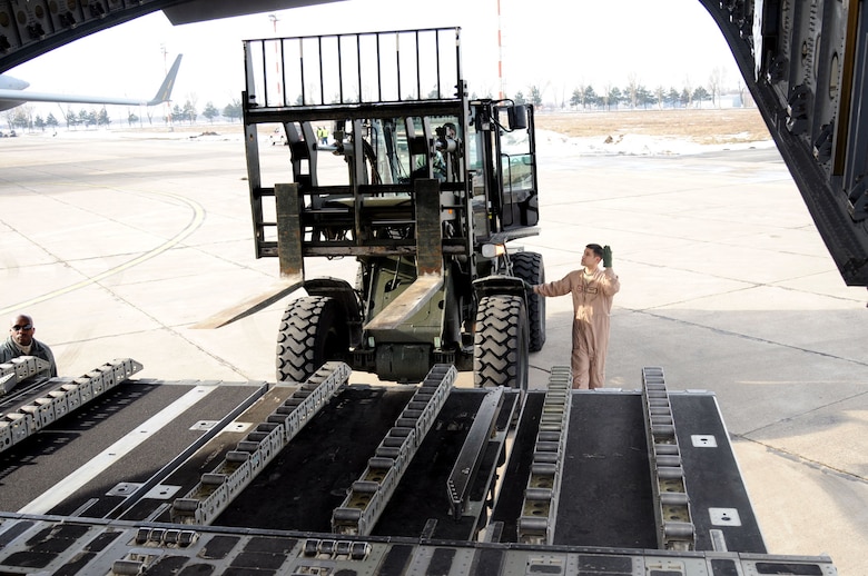 MIHAIL KOGALNICEANU AIR BASE, Romania - Airmen load cargo aboard a C-17 bound for Afghanistan. After more than a decade of operations at Manas, Kyrgystan, the Romanian location has become the U.S. military's main air hub for passengers and cargo into and out of Afghanistan.