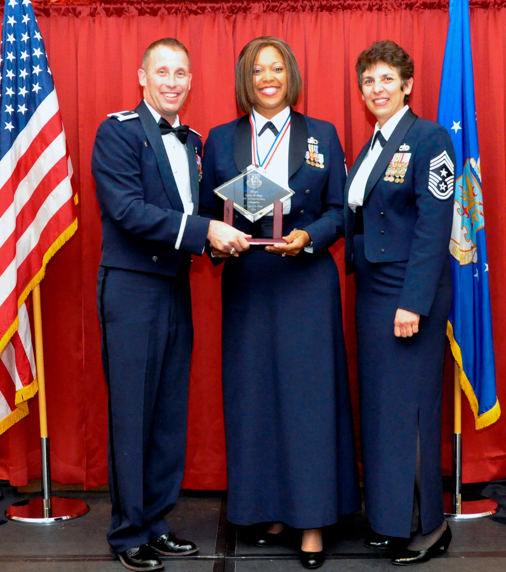 TRAVIS AIR FORCE BASE, Calif. -- Master Sgt. Doris Phillips was selected as the First Sergeant of the Year at the 349th AMW's Annual Awards Ball Feb. 8. Phillips is the "Shirt" for the 945th AMXS. She is pictured here with Wing Commander, Col. Matt Burger, and the Command Chief, CMSgt. "Sunny" Santos. (U.S. Air Force photo/Master Sgt. Rachel Martinez)
