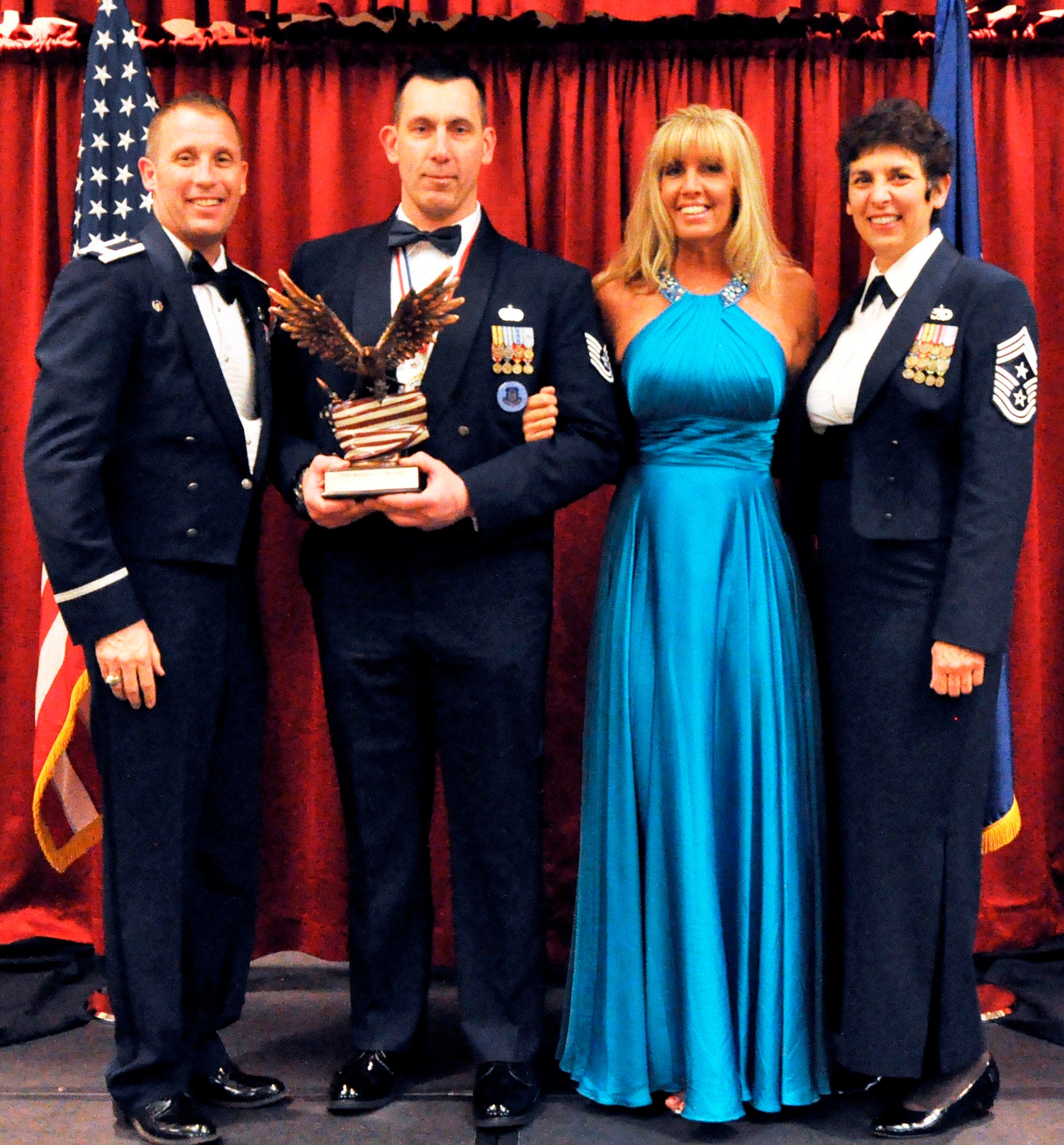 TRAVIS AIR FORCE BASE, Calif. -- Recruiter of the Year, Tech. Sgt. William Pullion, receives his trophy from Col. Matt Burger and CMSgt. "Sunny" Santos. Pullion is assigned as a line recruiter, to the Western Region office at the 349th AMW. The Annual Awards Ball held Feb. 8, recognizes the wing's top performers. (U.S. Air Force photo/Master Sgt. Rachel Martinez)