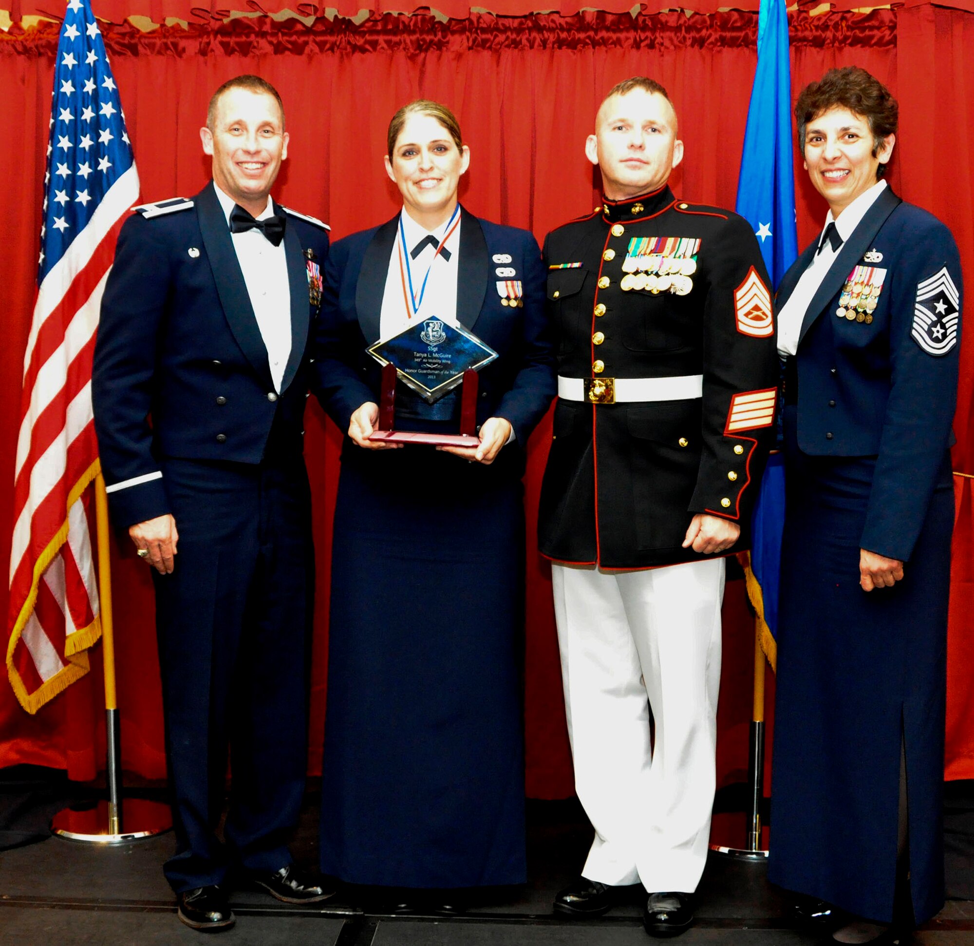 TRAVIS AIR FORCE BASE, Calif. -- Honor Guardsman of the Year, Staff Sgt. Tania McGuire, accepts her trophy from Col. Matt Burger and CMSgt. "Sunny" Santos, at the 349th AMW Annual Awards Ball Feb. 8. Serving the base Honor Guard is a special duty assignment for the "cream of the crop." McGuire is assigned to the 349th AMXS. (U.S. Air Force photo/Master Sgt. Rachel Martinez)