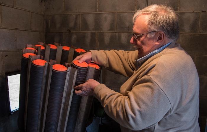 Larry Borowiecki, Joint Base Charleston Skeet and Trap Range volunteer, places clay targets into the throwing machine Feb. 14, 2014, at the Skeet and Trap Range on Joint Base Charleston – Air Base, S.C. The clay targets are flung into the air at high speeds from one station in trap shooting and two stations in skeet shooting. (U.S. Air Force photo/ Airman 1st Class Clayton Cupit)