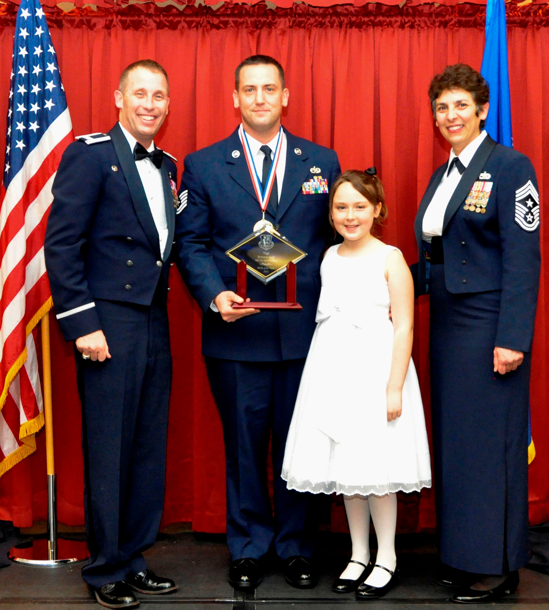 TRAVIS AIR FORCE BASE, Calif. --Noncommissioned Officer of the Year, Tech. Sgt. Richard Kroll, accepts his award from Wing Commander, Col. Matt Burger, and Command Chief, CMSgt. "Sunny" Santos, at the Annual Awards Ball. Kroll is assigned to the 749th Aircraft Maintenance Squadron, 349th Maintenance Group. He will continue on to compete at the Fourth Air Force level competition. (U.S. Air Force photo/Master Sgt. Rachel Martinez)