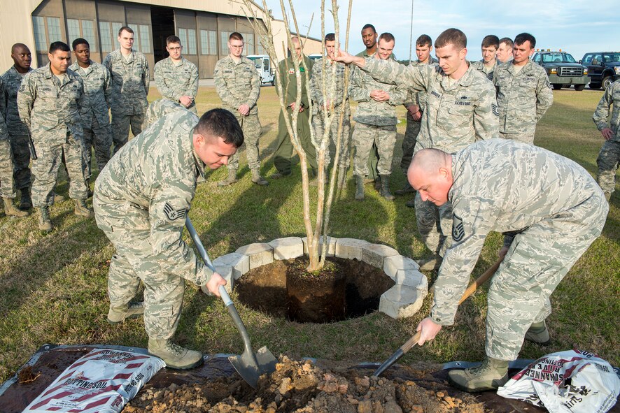 Airmen from the 41st Helicopter Maintenance Unit and the 41st Rescue Squadron plant a tree at Moody Air Force Base, Ga., Feb. 14, 2014. The Airmen were participating in a tree planting ceremony in remembrance of the crew members of the downed helicopter Jolly 22, an HH-60G Pave Hawk which crashed Jan. 7th on the Norfolk coast of England. (U.S. Air Force photo by Airman 1st Class Ryan Callaghan/Released)