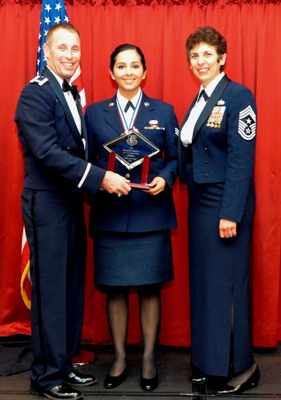 TRAVIS AIR FORCE BASE, Calif. -- 2013 Airman of the Year, Senior Amn. Elizabetih Watson, accepts her trophy from Col. Matt Burger, 349th Air Mobility Wing commander, and Wing Command Chief, Chief Master Sgt. Sandra "Sunny" Santos. Watson is assigned to the 349th Logistics Readiness Squadron, 349th Mission Support Group. She will continue on to compete at the Fourth Air Force level. (U.S. Air Force photo/Master Sgt. Rachel Martinez)
