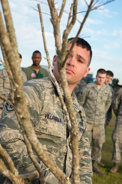 U.S. Air Force Staff Sgt. Stephen Villanella, 41st Helicopter Maintenance Unit quality assurance inspector, lowers a tree into the ground during a tree planting ceremony in remembrance of the crew members of the downed helicopter Jolly 22, an HH-60G Pave Hawk which crashed Jan. 7th on the Norfolk coast of England, at Moody Air Force base, Ga., Feb. 14, 2014. Several members of the crew were previously stationed at Moody. (U.S. Air Force photo by Airman 1st Class Ryan Callaghan/Released)