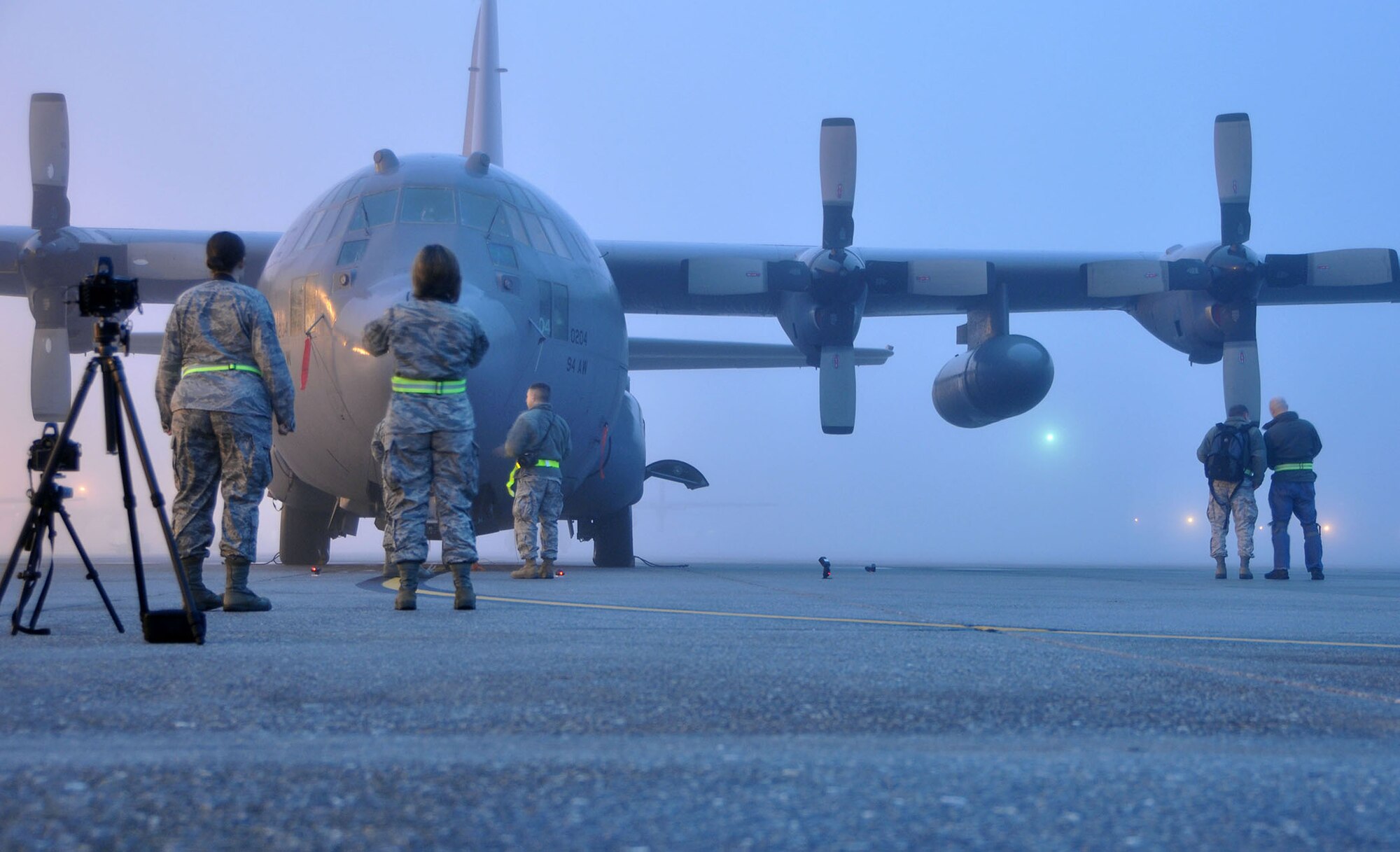 TRAVIS AIR FORCE BASE, Calif. --Photojournalists take sunrise photos of a C-130 Hercules during foggy conditions, to practice lighting techniques during a two-day course provided by professional aviation photographer Tony Granata, Feb. 2. (U.S. Air Force photo/Senior Airman Cindy Alejandrez)