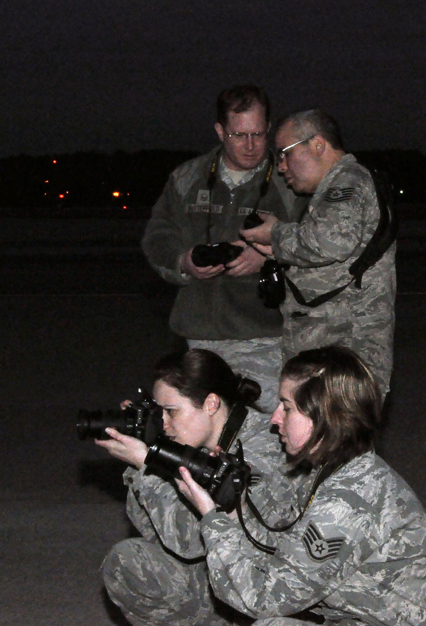 TRAVIS AIR FORCE BASE, Calif. --Photojournalists take sunrise photos of a C-130 Hercules during foggy conditions, to practice lighting techniques during a two-day course provided by professional aviation photographer Tony Granata, Feb. 2. (U.S. Air Force photo/Senior Airman Cindy Alejandrez)
