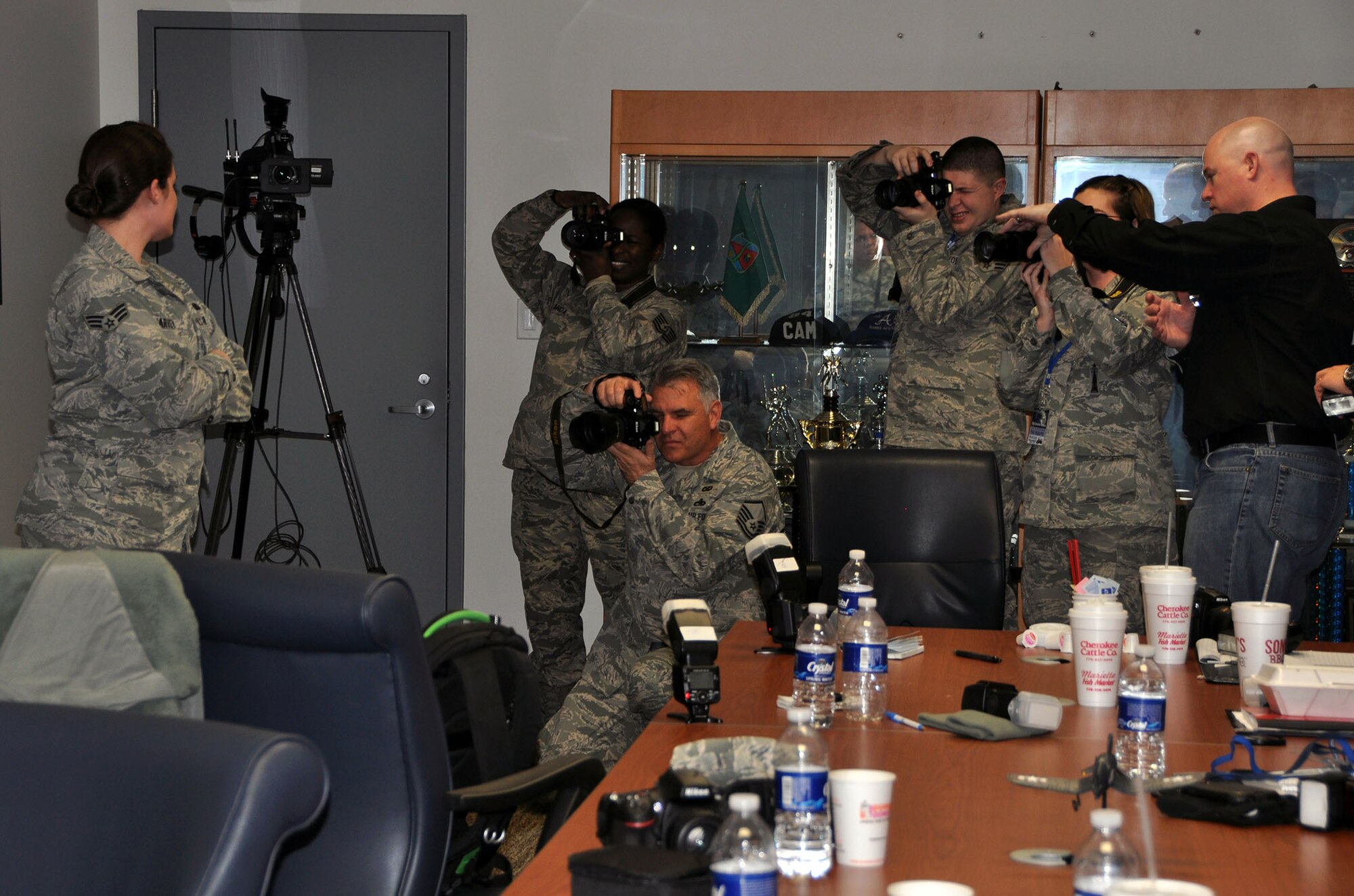 TRAVIS AIR FORCE BASE, Calif. --Photojournalists take sunrise photos of a C-130 Hercules during foggy conditions, to practice lighting techniques during a two-day course provided by professional aviation photographer Tony Granata, Feb. 2. (U.S. Air Force photo/Senior Airman Cindy Alejandrez)