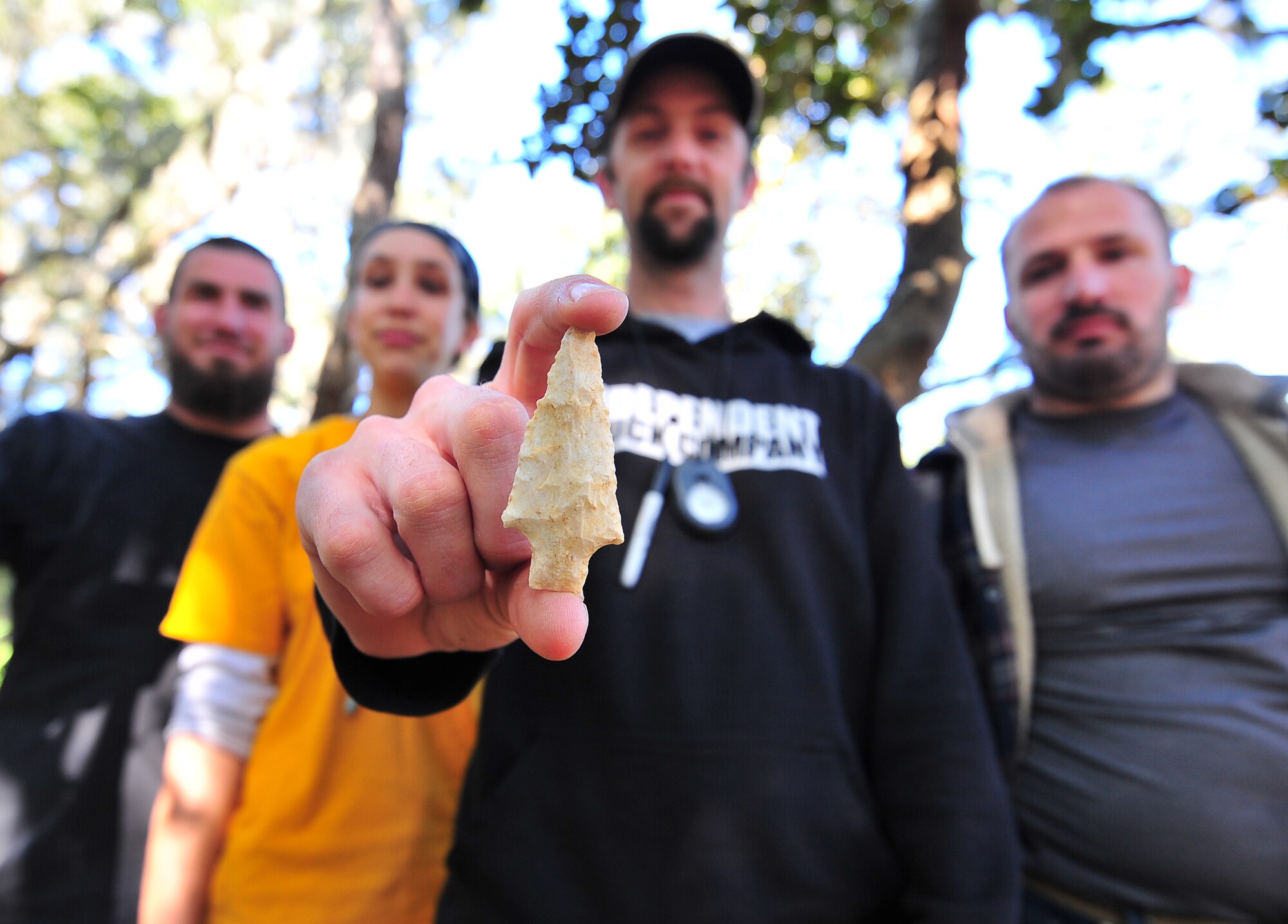 The Prentice Thomas and Associates archeologist team, from Fort Walton Beach, Fla., pose with a dart point Feb. 14, at Tyndall. The team predicts that the dart point they found is approximately a few thousand years old. (U.S. Air Force photo by Airman 1st Class Sergio A. Gamboa)