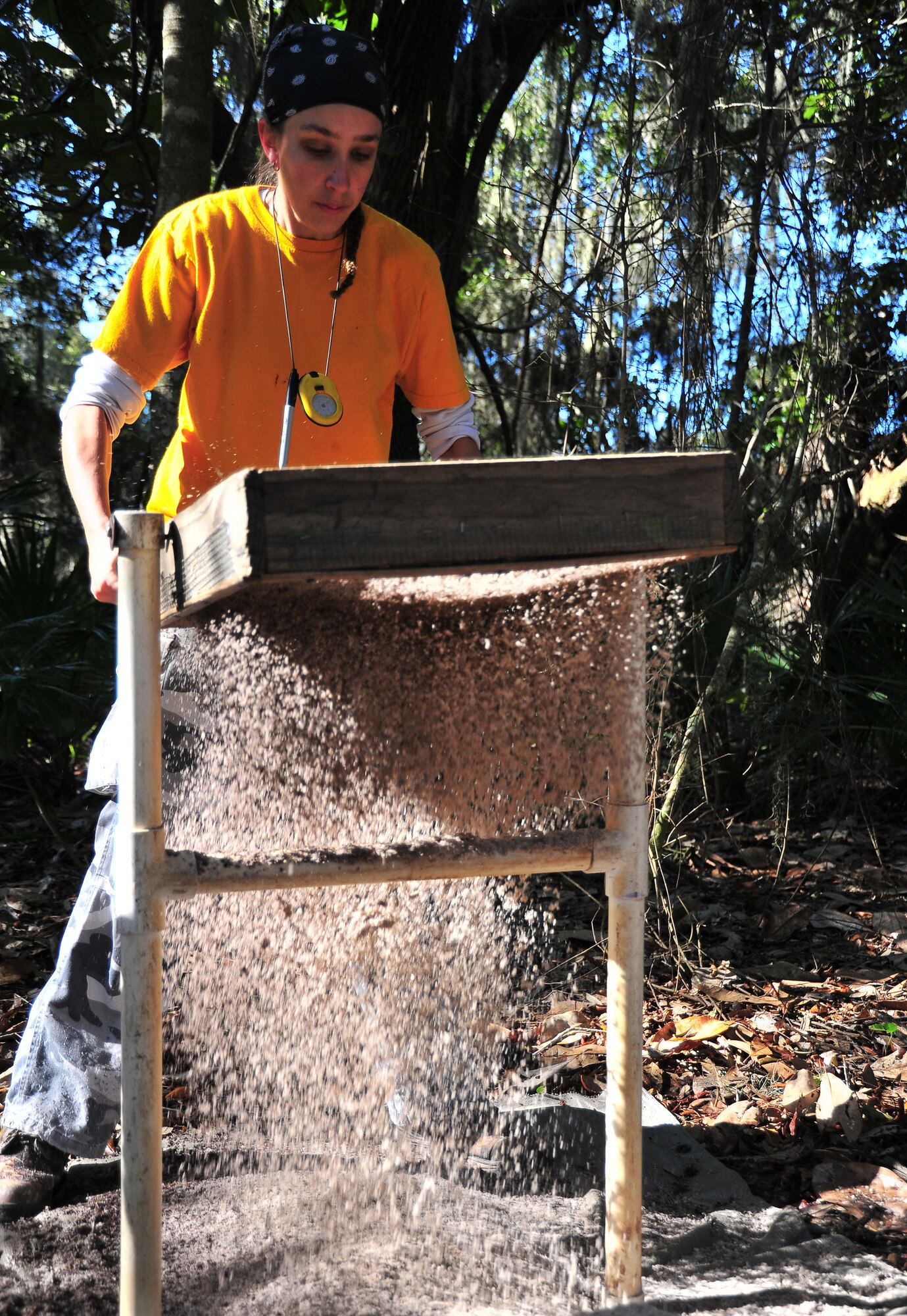 Sarah Deihl, Prentice Thomas and Associates team archeologist, runs sand through a sifter Feb. 14, at Tyndall. She hopes to find any type of evidence of past cultures or items of historic value. (U.S. Air Force photo by Airman 1st Class Sergio A. Gamboa)