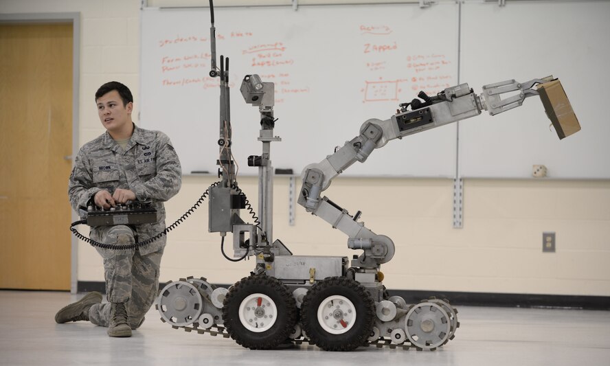 U.S. Air Force Senior Airman Christopher Brown, 20th Civil Engineer Squadron explosive ordinance disposal technician, demonstrates the capabilities of the F6A Andros robot at Shaw Heights Elementary School, Feb. 10, 2014. Brown was showcasing the kids how the robot would work if it were to be used in an actual bomb diffusing situation. (U.S. Air Force photo by Airman 1st Class Michael A. Cossaboom/released)  
