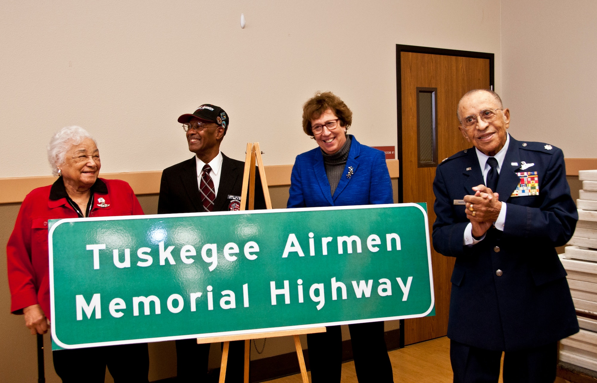 Lt. Col. (ret.) James Warren, Senator Lois Wolk, Aubrey Matthews  and Edith Roberts proudly present the Tuskegee Airmen Memorial Highway sign that will be displayed on Interstate 80 Feb. 6 at the Veterans Hall in Dixon, Ca. (U.S. Air Force photo/Senior Airman Madelyn Brown)