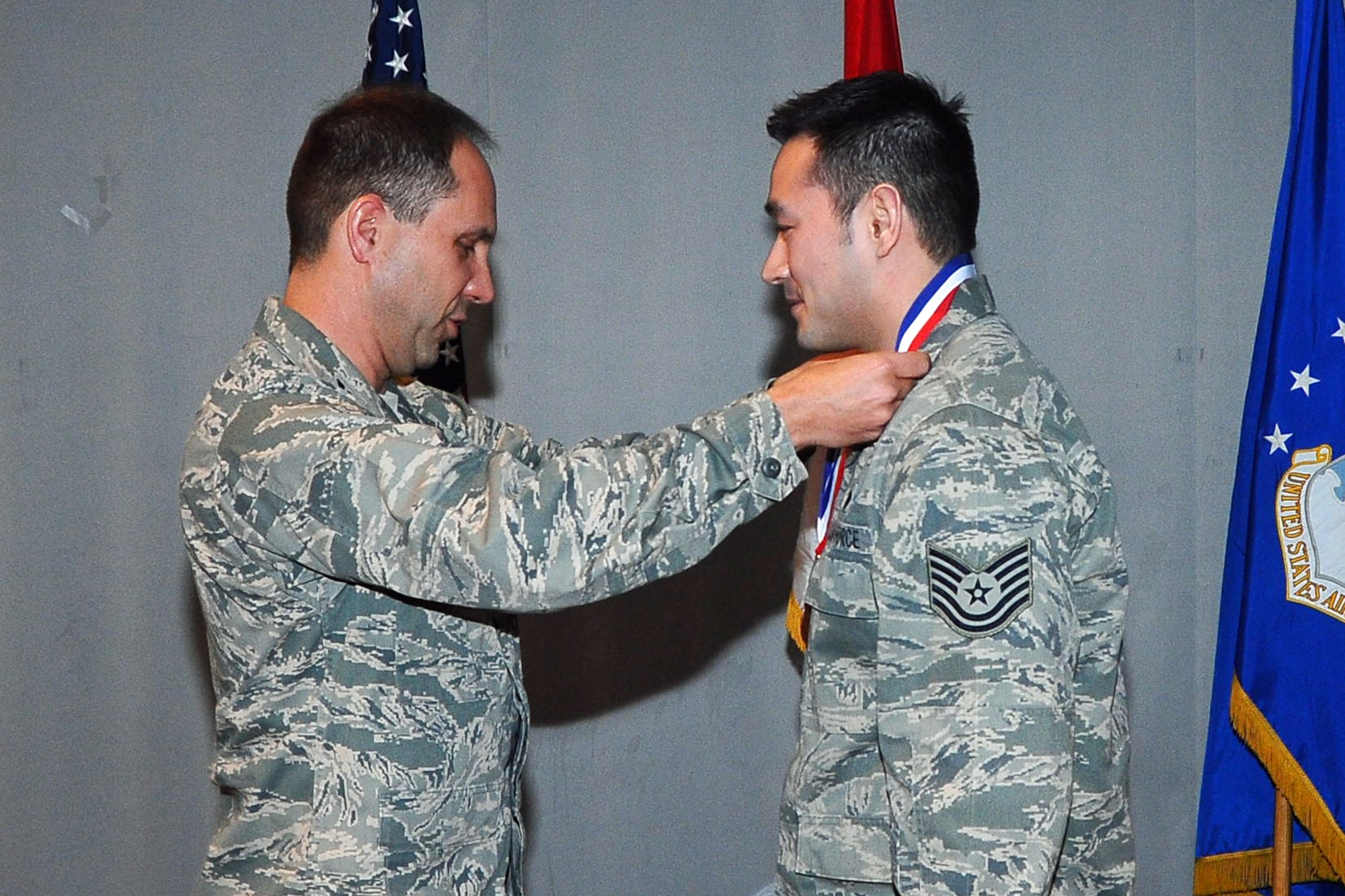 THULE AIR BASE, Greenland – Col. John Shaw (left), 21st Space Wing commander, honors Tech. Sgt. Jeffrey Mikell, 821st Support Squadron, Feb. 6 at Thule AB. Mikell was named the Honor Guard NCO of the Year during the 21st Space Wing annual awards dinner held Jan. 28 at Peterson. Thule AB is one of the 21st Space Wing’s six installations it operates, and is located more than 750 miles north of the Arctic Circle. (U.S. Air Force photo)