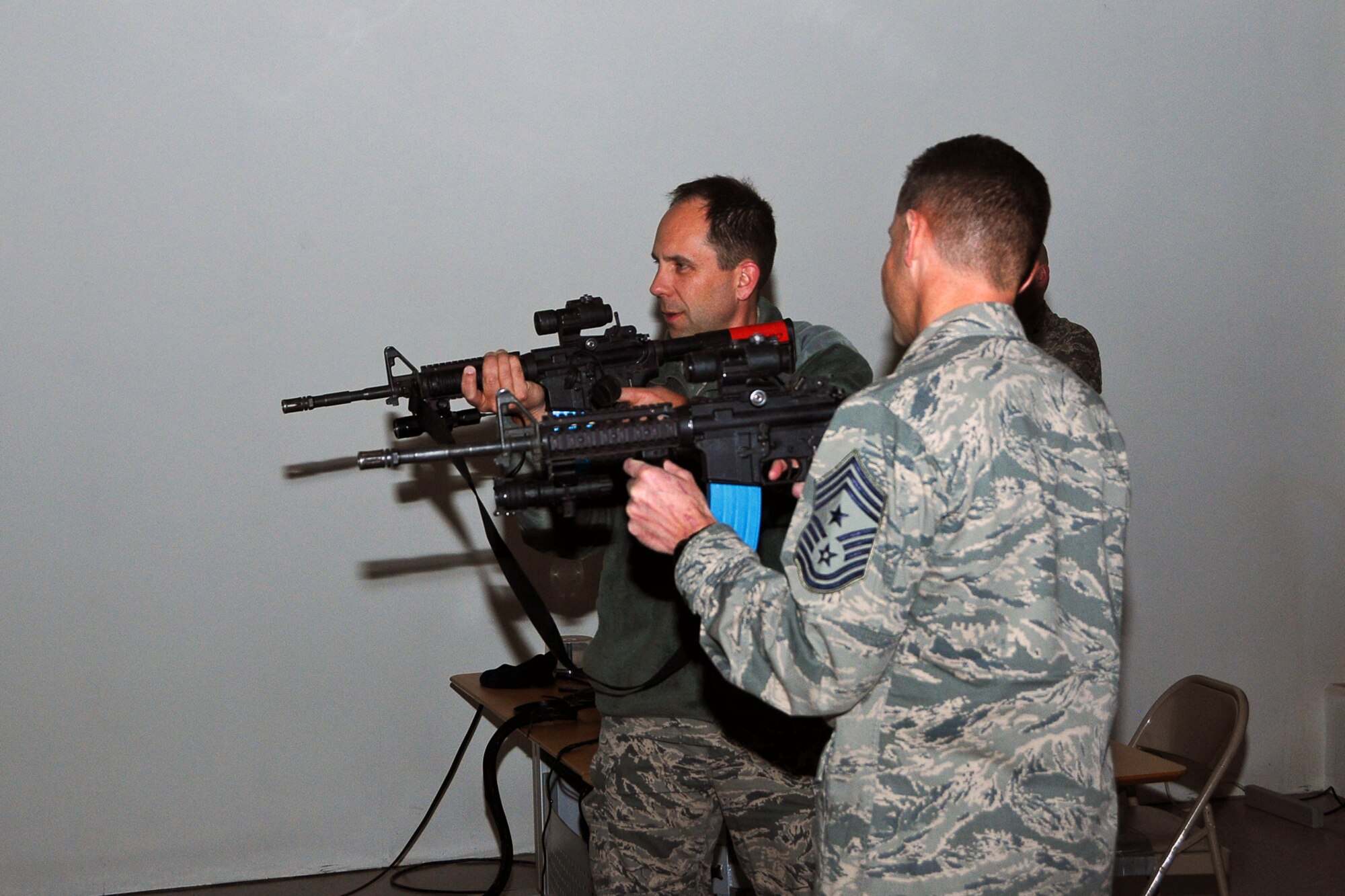 THULE AIR BASE, Greenland – Col. John Shaw (left), 21st Space Wing commander, and Chief Master Sgt. Rich Redman, 21st SW command chief, take a shot at a simulator Feb. 6 during a visit to the 821st Mission Support Group at Thule Air Base. Thule AB is one of the 21st Space Wing’s six installations it operates, and is located more than 750 miles north of the Arctic Circle. (U.S. Air Force photo)