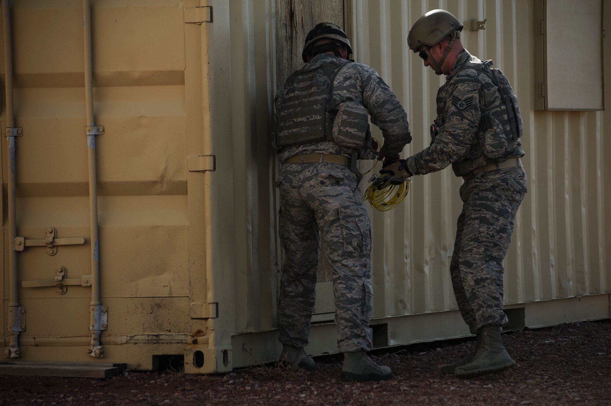 Staff Sgt. John Bonebrake, 620th Ground Support Training Squadron breacher instructor, and Staff Sgt. David Meadows, 620th GSTS formal training instructor, demonstrate how to breach into a building using an improvised door charge at Camp Guernsey, Wyo., Feb. 16, 2014. (U.S. Air Force photo by Staff Sgt. Jonathan Snyder/RELEASED)
  