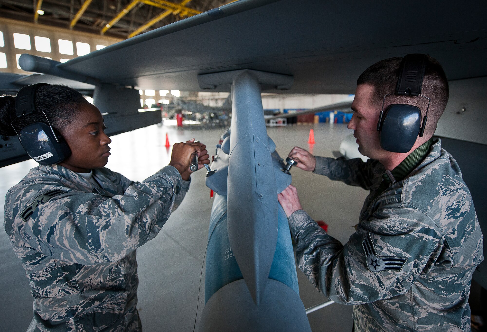 Airman 1st Class Quionjay Jackson and Senior Airman Thomas Schultz, of the 96th Aircraft Maintenance Squadron Blue, tighten down a Guided Bomb Unit-12 to their F-16 Fighting Falcon during the annual weapons load crew of the year competition Feb. 14 at Eglin Air Force Base, Fla.  Teams from AMU Blue battled AMU Red in loading a GBU, AIM-9 and an AIM-120 on their respective aircraft.  The winners will be announced at the 96th Maintenance Group banquet.  (U.S. Air Force photo/Samuel King Jr.)